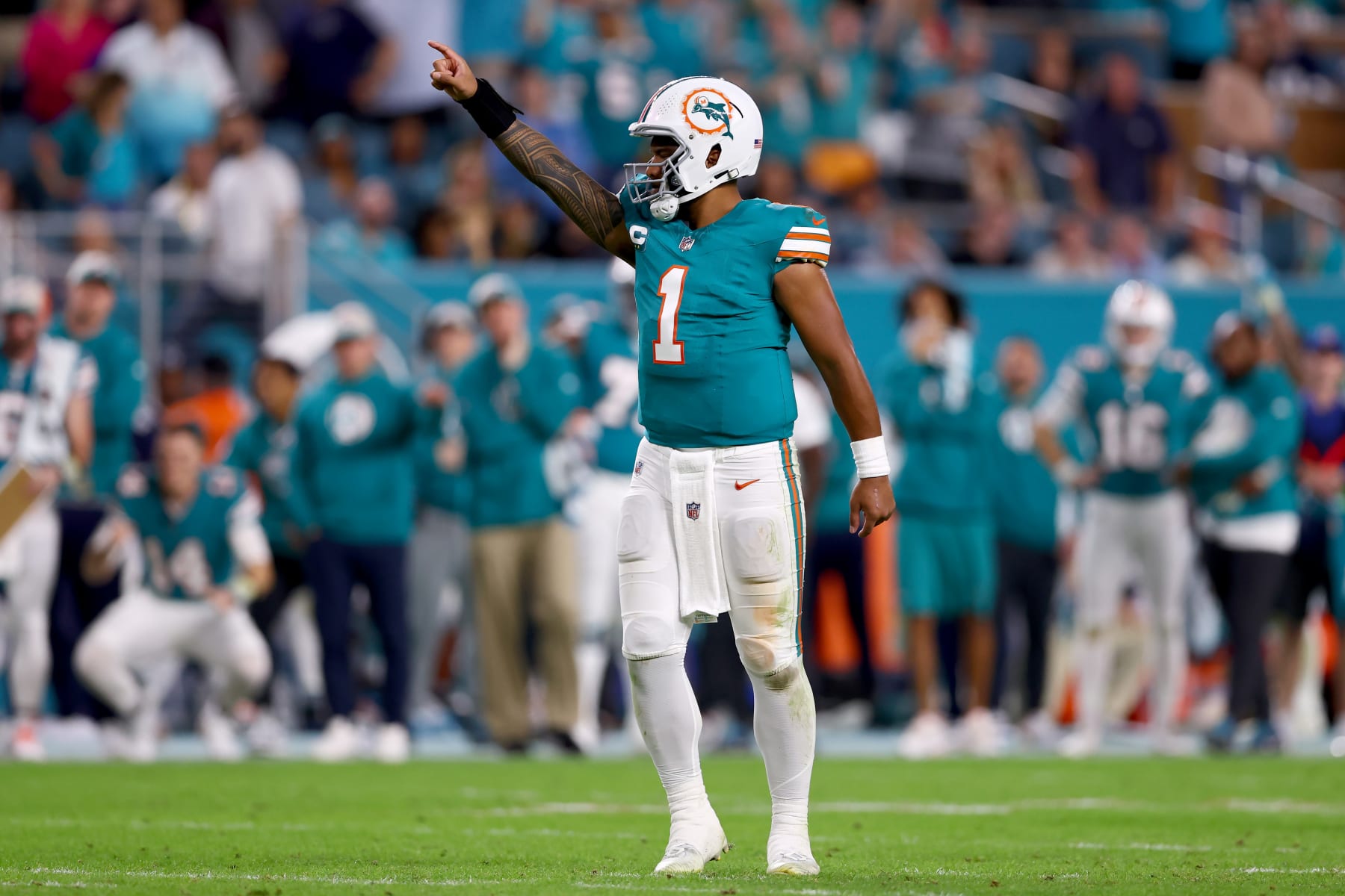 MIAMI GARDENS, FLORIDA - DECEMBER 24: Tua Tagovailoa #1 of the Miami Dolphins reacts after a first down during the fourth quarter in the game against the Dallas Cowboys at Hard Rock Stadium on December 24, 2023 in Miami Gardens, Florida. (Photo by Megan Briggs/Getty Images)