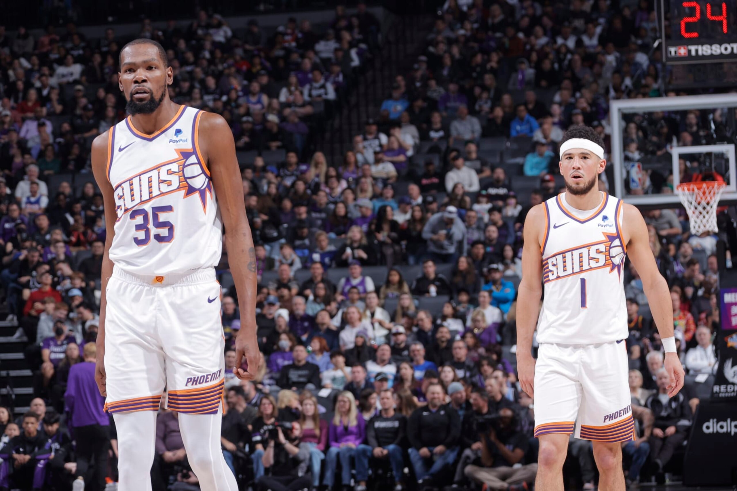 SACRAMENTO, CA - DECEMBER 22:  Kevin Durant #35 of the Phoenix Suns & Devin Booker #1 of the Phoenix Suns looks on during the game on December 22, 2023 at Golden 1 Center in Sacramento, California. NOTE TO USER: User expressly acknowledges and agrees that, by downloading and or using this Photograph, user is consenting to the terms and conditions of the Getty Images License Agreement. Mandatory Copyright Notice: Copyright 2023 NBAE (Photo by Rocky Widner/NBAE via Getty Images)
