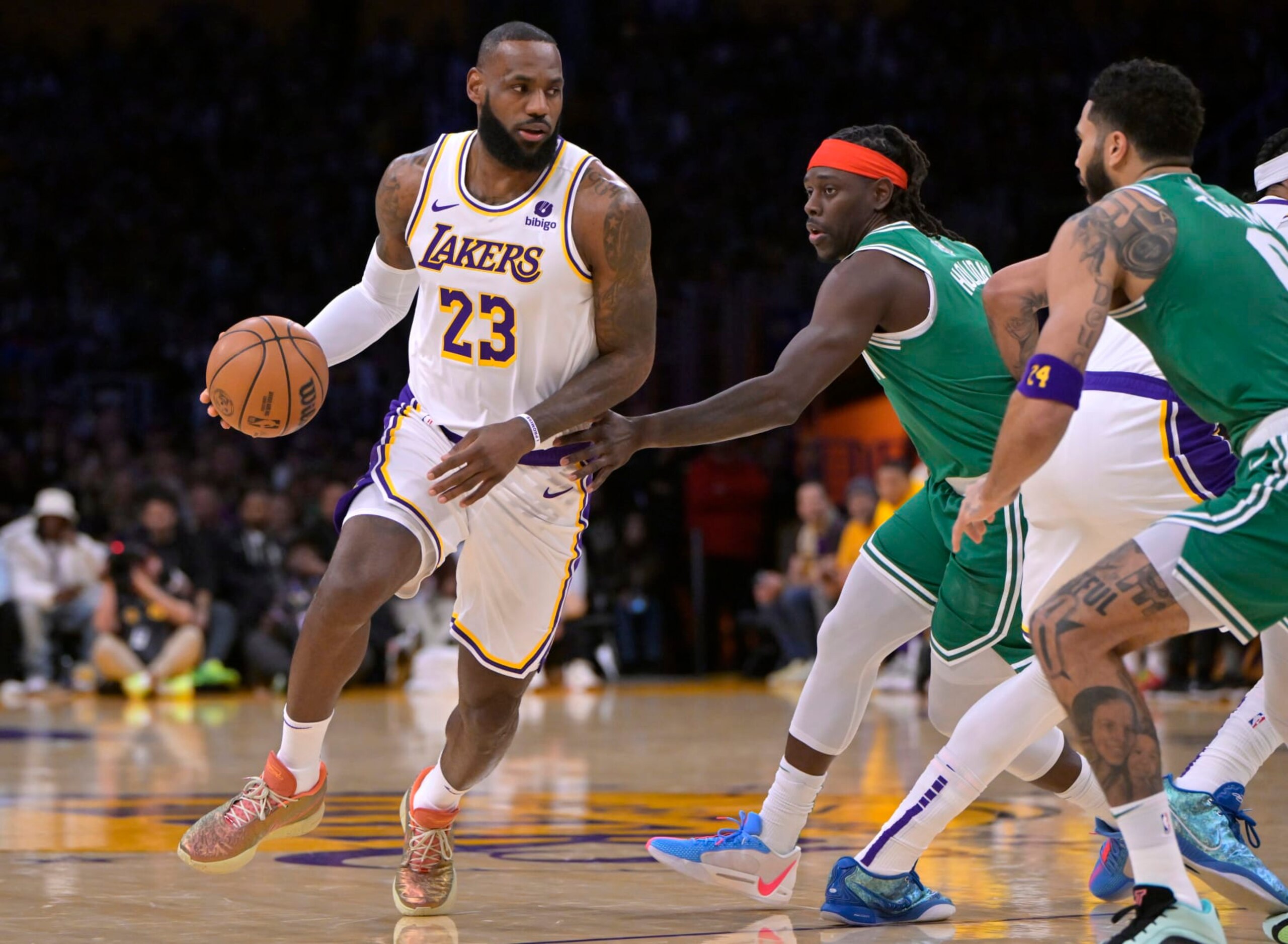 LOS ANGELES, CALIFORNIA - DECEMBER 25: LeBron James #23 of the Los Angeles Lakers drives past Jrue Holiday #4 of the Boston Celtics in the first half at Crypto.com Arena on December 25, 2023 in Los Angeles, California. NOTE TO USER: User expressly acknowledges and agrees that, by downloading and or using this photograph, User is consenting to the terms and conditions of the Getty Images License Agreement.(Photo by Jayne Kamin-Oncea/Getty Images)
