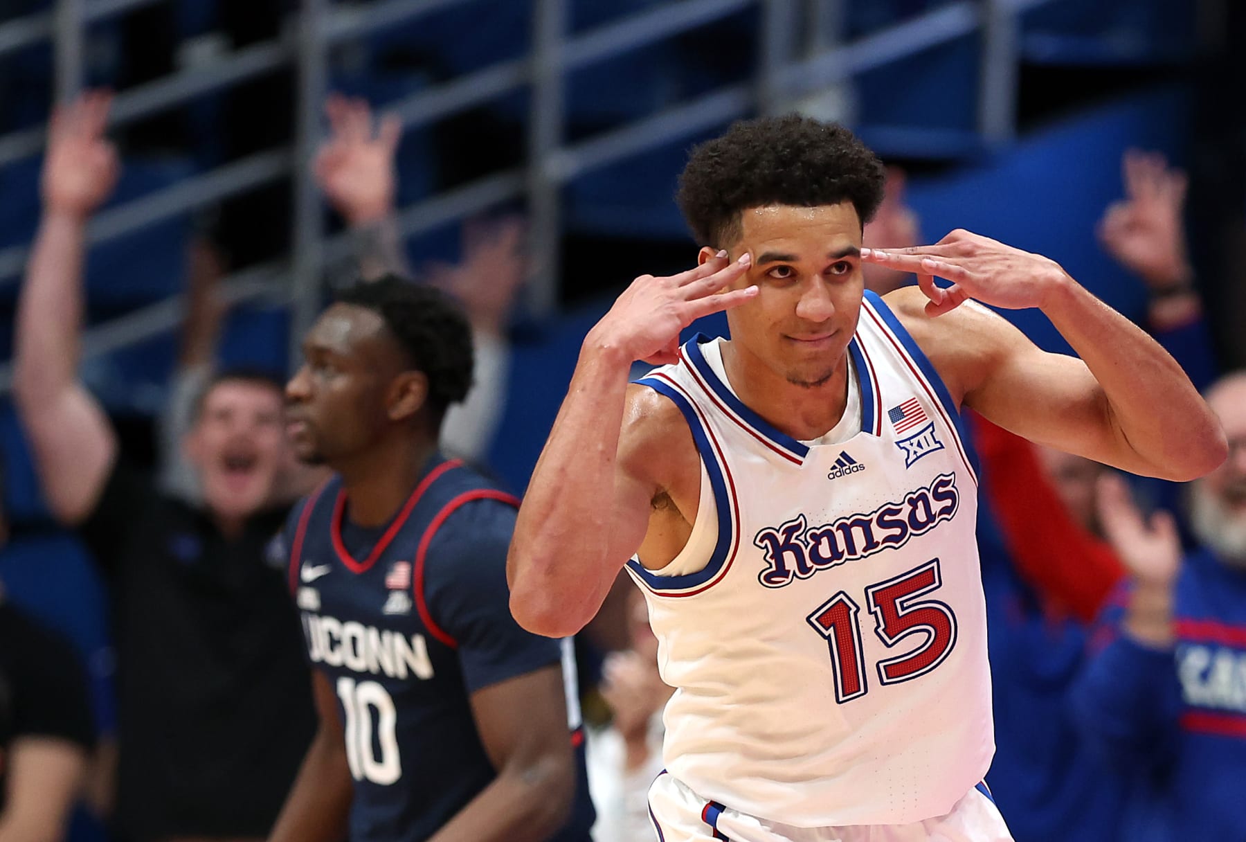 LAWRENCE, KANSAS - DECEMBER 01:  Kevin McCullar Jr. #15 of the Kansas Jayhawks reacts after making a three-pointer during the 2nd half of the game against the Connecticut Huskies at Allen Fieldhouse on December 01, 2023 in Lawrence, Kansas. (Photo by Jamie Squire/Getty Images)