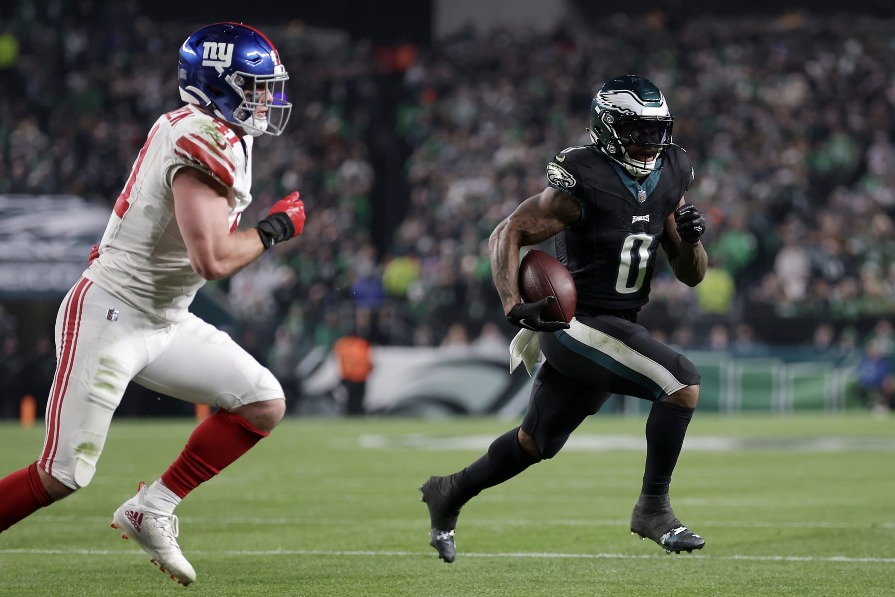 PHILADELPHIA, PENNSYLVANIA - DECEMBER 25: D'Andre Swift #0 of the Philadelphia Eagles runs the ball against Micah McFadden #41 of the New York Giants during the first quarter at Lincoln Financial Field on December 25, 2023 in Philadelphia, Pennsylvania. (Photo by Adam Hunger/Getty Images)