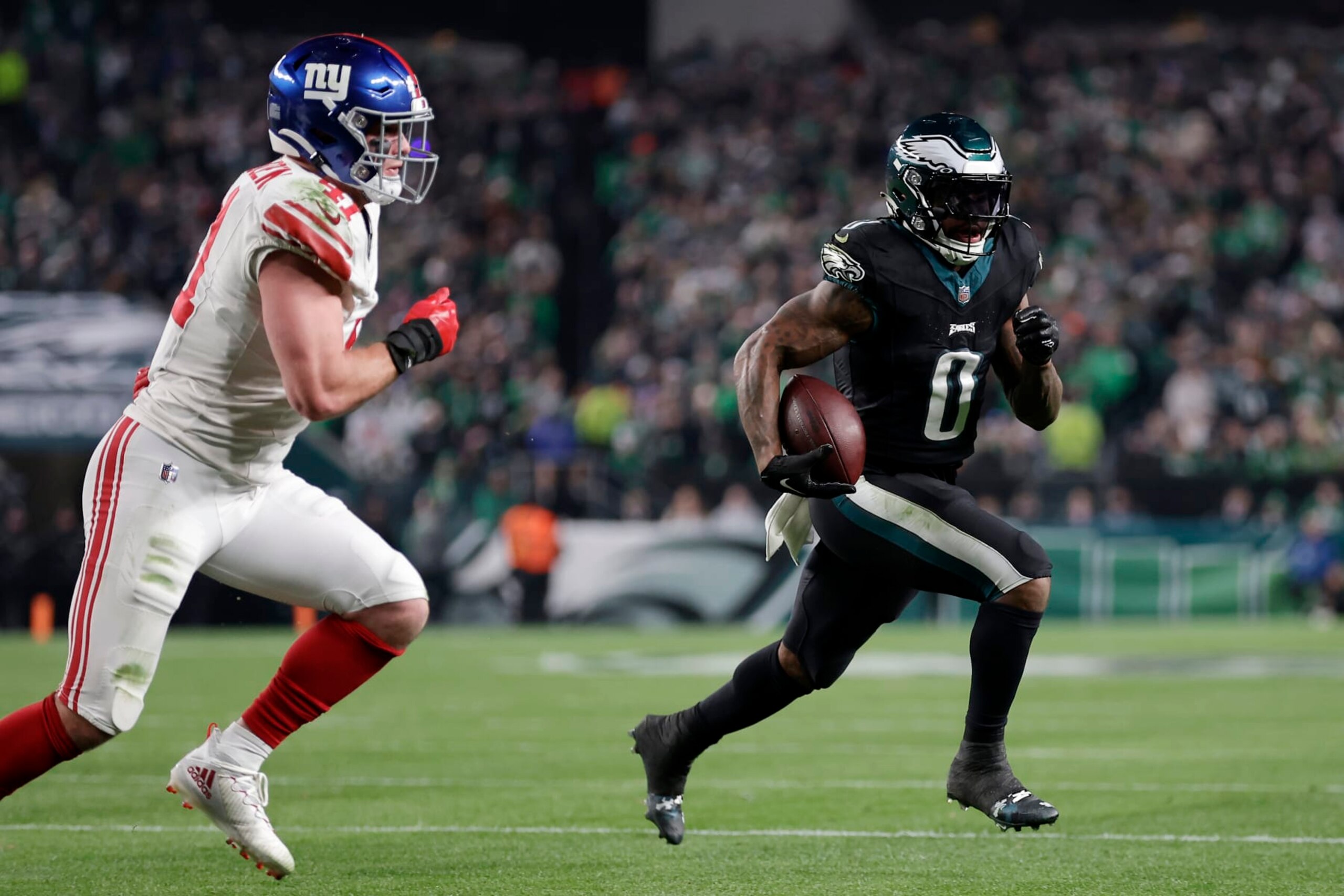 PHILADELPHIA, PENNSYLVANIA - DECEMBER 25: D'Andre Swift #0 of the Philadelphia Eagles runs the ball against Micah McFadden #41 of the New York Giants during the first quarter at Lincoln Financial Field on December 25, 2023 in Philadelphia, Pennsylvania. (Photo by Adam Hunger/Getty Images)