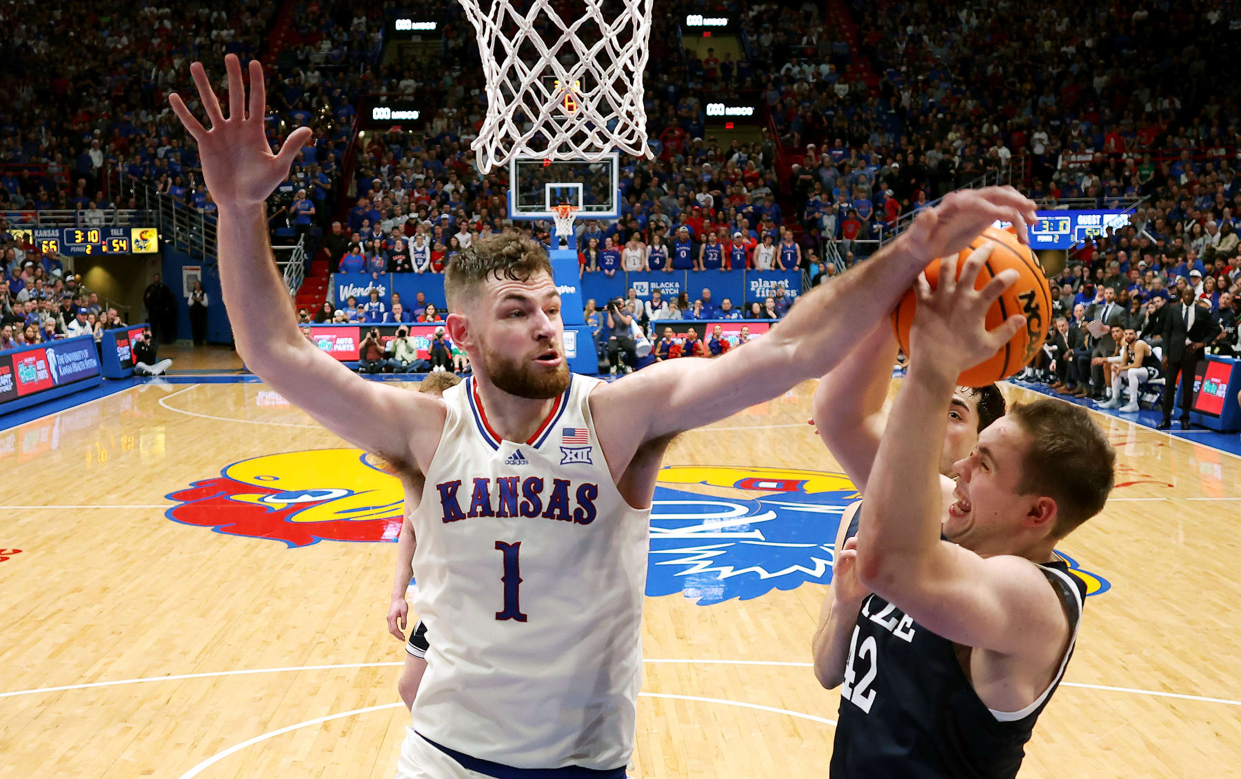 LAWRENCE, KANSAS - DECEMBER 22:  Hunter Dickinson #1 of the Kansas Jayhawks blocks a shot by Nick Townsend #42 of the Yale Bulldogs during the game at Allen Fieldhouse on December 22, 2023 in Lawrence, Kansas. (Photo by Jamie Squire/Getty Images)