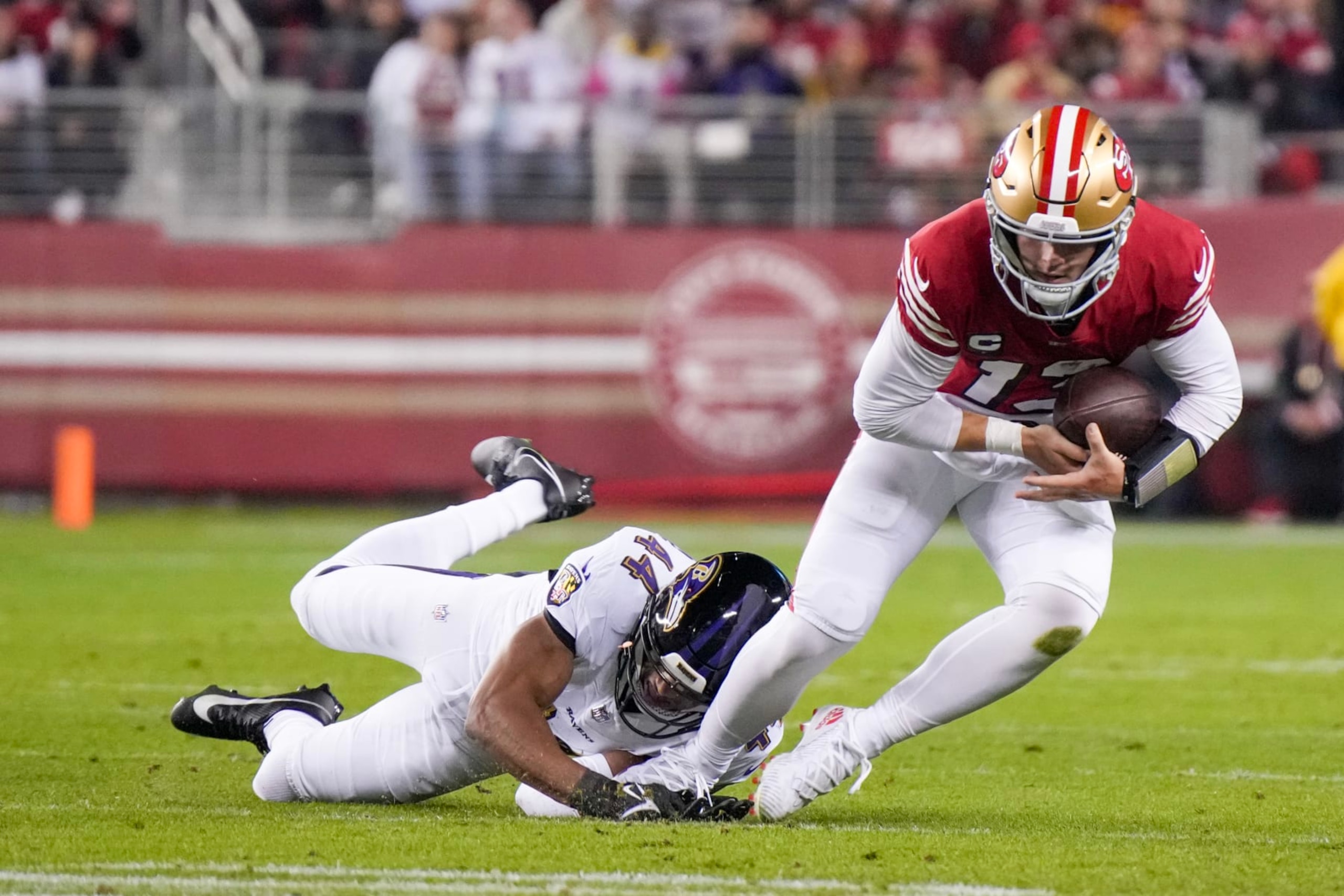 SANTA CLARA, CALIFORNIA - DECEMBER 25: Marlon Humphrey #44 of the Baltimore Ravens sacks Brock Purdy #13 of the San Francisco 49ers during the first quarter at Levi's Stadium on December 25, 2023 in Santa Clara, California. (Photo by Loren Elliott/Getty Images)