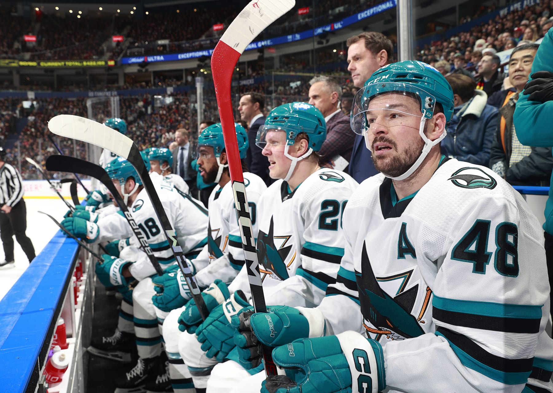 VANCOUVER, CANADA - DECEMBER 23: Tomas Hertl #48 of the San Jose Sharks looks on from the bench during their NHL game against the Vancouver Canucks at Rogers Arena on December 23, 2023 in Vancouver, British Columbia, Canada.  (Photo by Jeff Vinnick/NHLI via Getty Images)