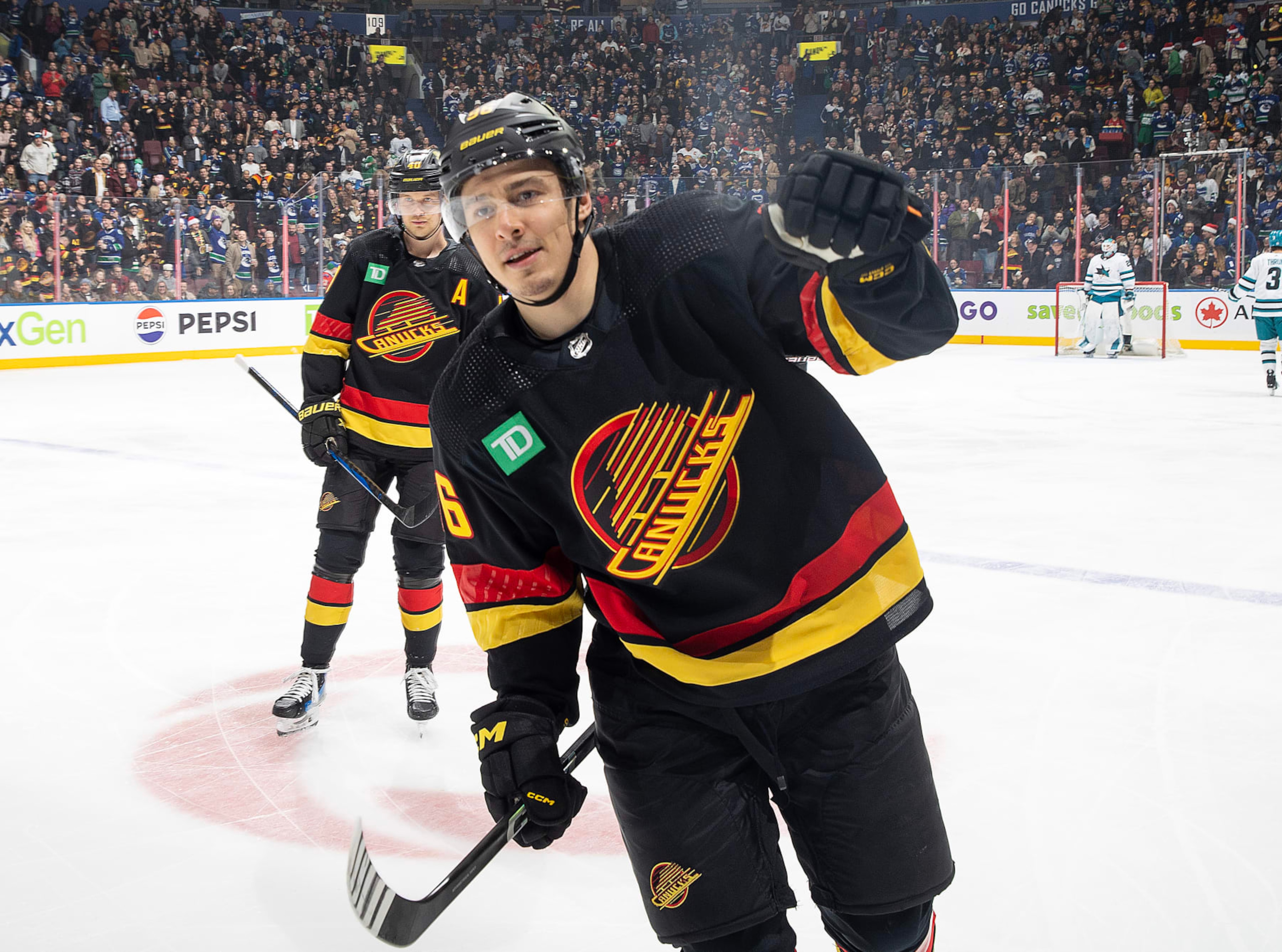 VANCOUVER, CANADA - DECEMBER 23: Andrei Kuzmenko #96 of the Vancouver Canucks skates back to the bench to celebrate his goal with teammates during the first period of their NHL game against the San Jose Sharks at Rogers Arena on December 23, 2023 in Vancouver, British Columbia, Canada. (Photo by Jeff Vinnick/NHLI via Getty Images) VANCOUVER, CANADA - DECEMBER 23: Andrei Kuzmenko #96 of the Vancouver Canucks skates back to the bench to celebrate his goal with teammates during the first period of their NHL game against the San Jose Sharks at Rogers Arena on December 23, 2023 in Vancouver, British Columbia, Canada. (Photo by Jeff Vinnick/NHLI via Getty Images)
