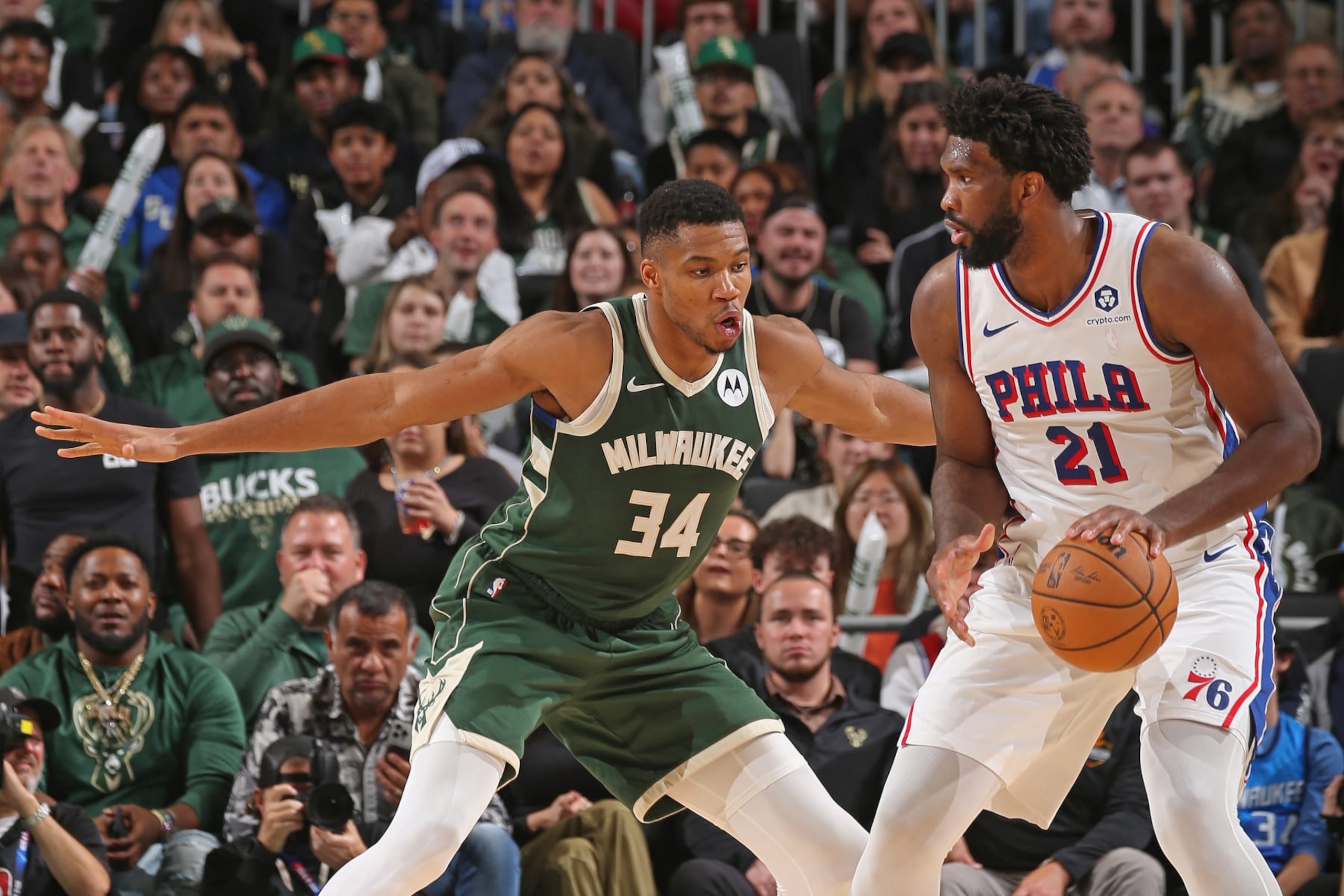 MILWAUKEE, WI - OCTOBER 26: Giannis Antetokounmpo #34 of the Milwaukee Bucks plays defense against Joel Embiid #21 of the Philadelphia 76ers on October 26, 2023 at the Fiserv Forum Center in Milwaukee, Wisconsin. NOTE TO USER: User expressly acknowledges and agrees that, by downloading and or using this Photograph, user is consenting to the terms and conditions of the Getty Images License Agreement. Mandatory Copyright Notice: Copyright 2023 NBAE (Photo by Gary Dineen/NBAE via Getty Images). MILWAUKEE, WI - OCTOBER 26: Giannis Antetokounmpo #34 of the Milwaukee Bucks plays defense against Joel Embiid #21 of the Philadelphia 76ers on October 26, 2023 at the Fiserv Forum Center in Milwaukee, Wisconsin. NOTE TO USER: User expressly acknowledges and agrees that, by downloading and or using this Photograph, user is consenting to the terms and conditions of the Getty Images License Agreement. Mandatory Copyright Notice: Copyright 2023 NBAE (Photo by Gary Dineen/NBAE via Getty Images).