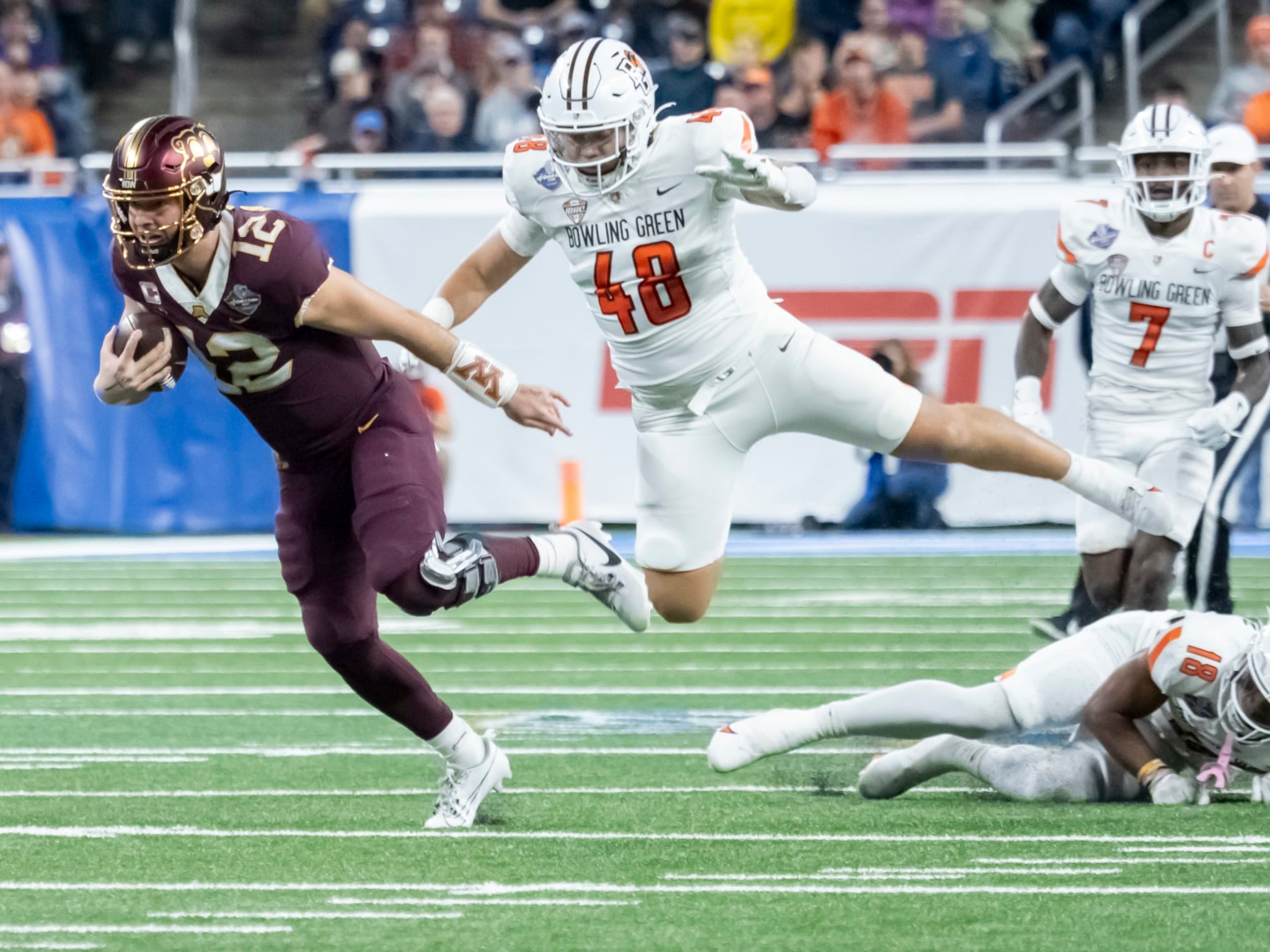 DETROIT, MI - DECEMBER 26: Minnesota Golden Gophers quarterback Cole Kramer (12) runs the ball for a first down against Bowling Green Falcons linebacker Myles Bradley (48) during the Quick Lane Bowl between the Bowling Green Falcons and the Minnesota Golden Gophers on December 26, 2023 at Ford Field in Detroit, Michigan. (Photo by Joseph Weiser/Icon Sportswire via Getty Images) DETROIT, MI - DECEMBER 26: Minnesota Golden Gophers quarterback Cole Kramer (12) runs the ball for a first down against Bowling Green Falcons linebacker Myles Bradley (48) during the Quick Lane Bowl between the Bowling Green Falcons and the Minnesota Golden Gophers on December 26, 2023 at Ford Field in Detroit, Michigan. (Photo by Joseph Weiser/Icon Sportswire via Getty Images)