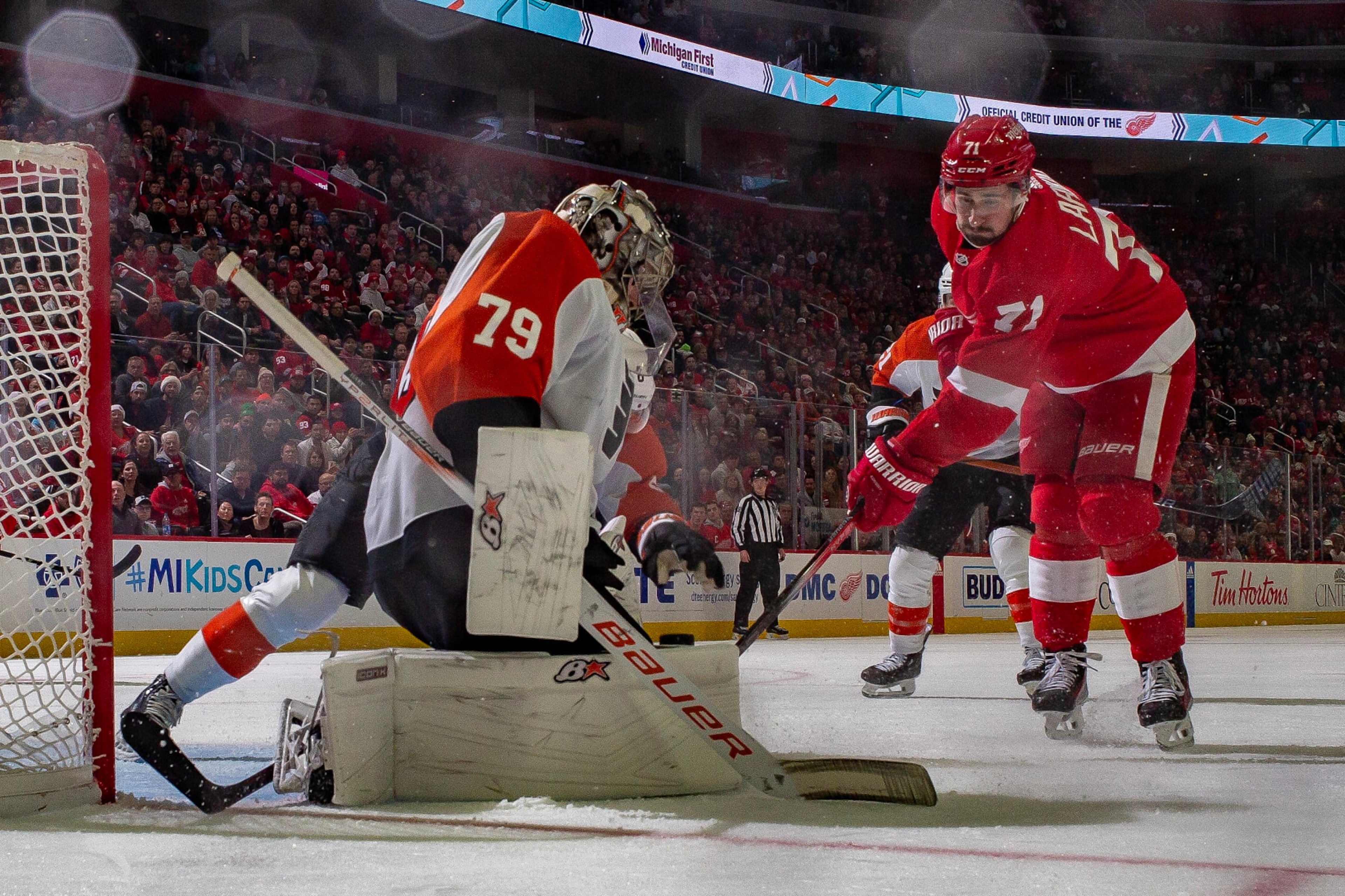 DETROIT, MI - DECEMBER 22: Carter Hart #79 of the Philadelphia Flyers makes a save as Dylan Larkin #71 of the Detroit Red Wings looks for the rebound during the second period at Little Caesars Arena on December 22, 2023 in Detroit, Michigan. Detroit defeated Philadelphia 7-6 in O.T.. (Photo by Dave Reginek/NHLI via Getty Images) DETROIT, MI - DECEMBER 22: Carter Hart #79 of the Philadelphia Flyers makes a save as Dylan Larkin #71 of the Detroit Red Wings looks for the rebound during the second period at Little Caesars Arena on December 22, 2023 in Detroit, Michigan. Detroit defeated Philadelphia 7-6 in O.T.. (Photo by Dave Reginek/NHLI via Getty Images)