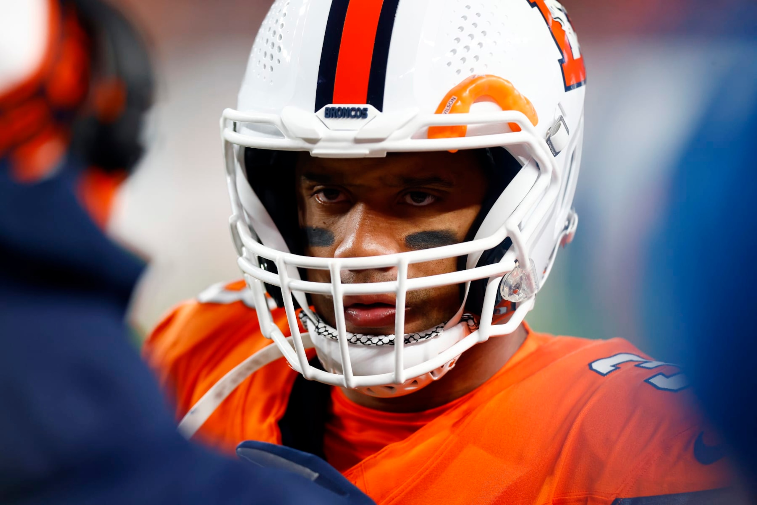 DENVER, COLORADO - DECEMBER 24:  Quarterback Russell Wilson #3 of the Denver Broncos talks with coaches during a timeout in the 2nd quarter of the game against the New England Patriots at Empower Field At Mile High on December 24, 2023 in Denver, Colorado. (Photo by Justin Edmonds/Getty Images)