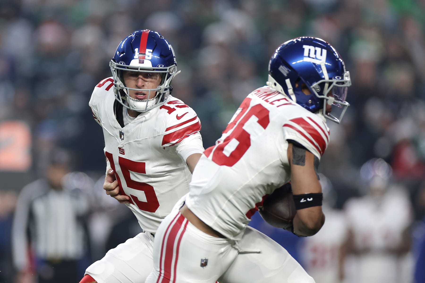 Tommy DeVito hands off to Saquon Barkley