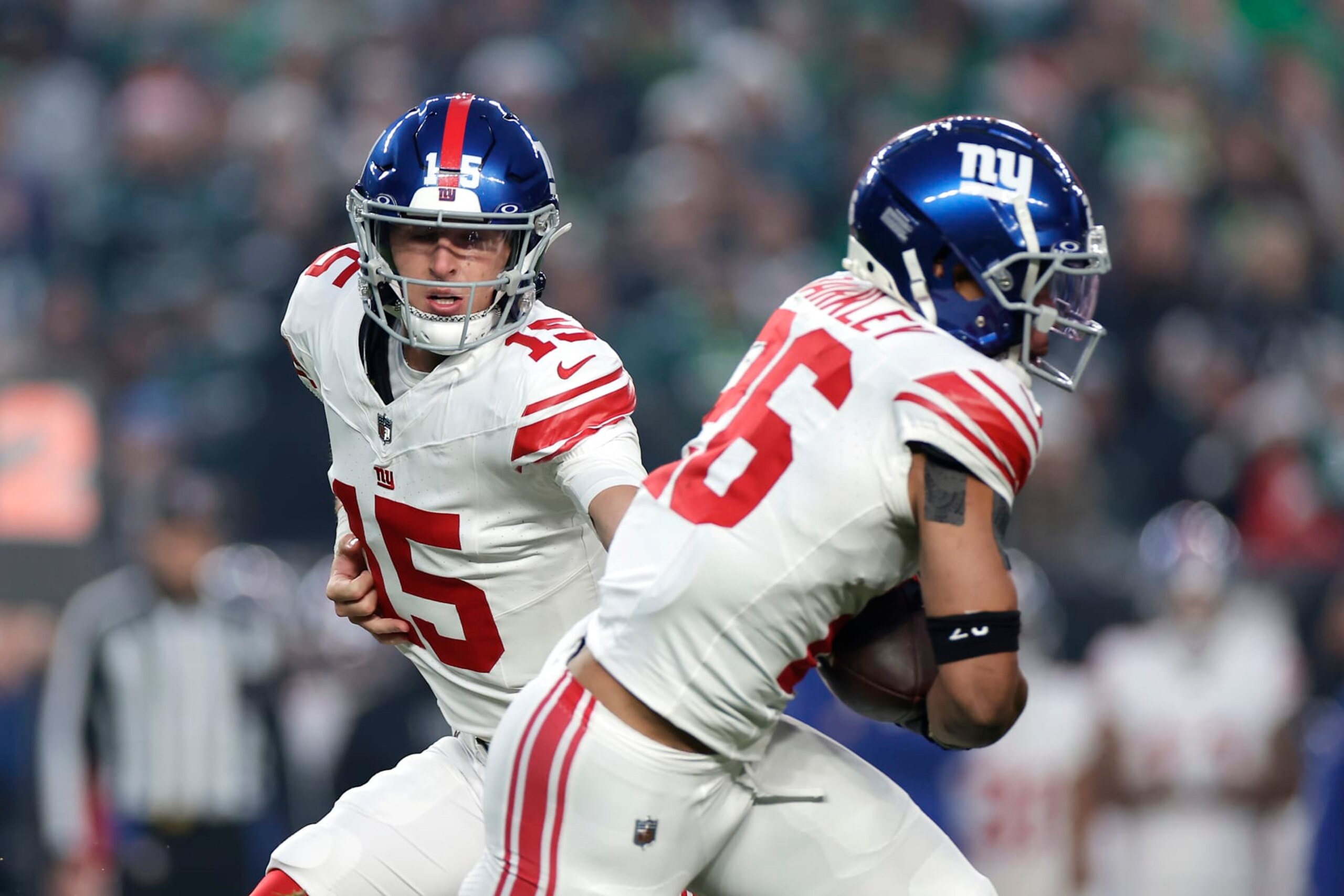 Tommy DeVito hands off to Saquon Barkley