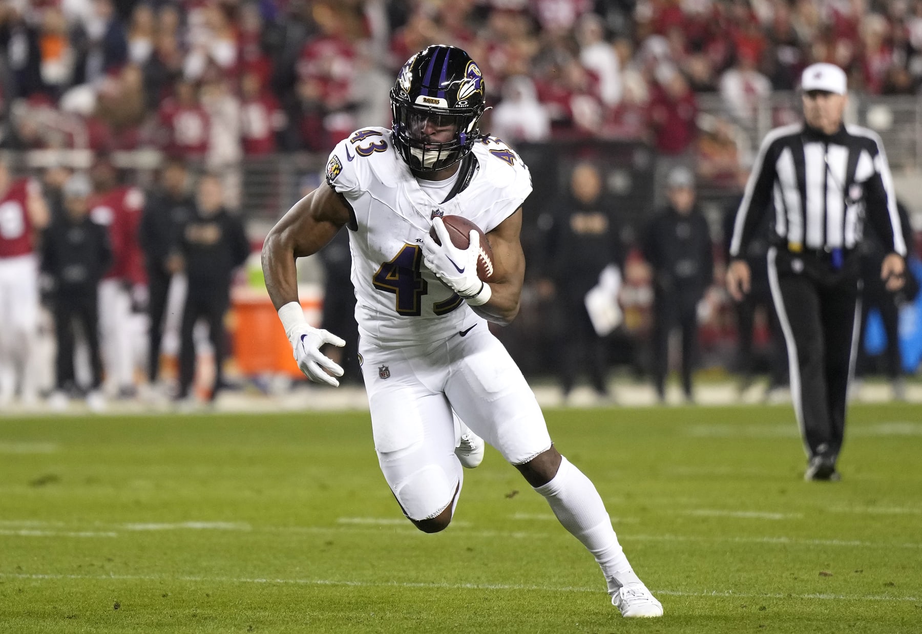 SANTA CLARA, CALIFORNIA - DECEMBER 25: Justice Hill #43 of the Baltimore Ravens carries the ball against the San Francisco 49ers during the first quarter of an NFL football game at Levi's Stadium on December 25, 2023 in Santa Clara, California. (Photo by Thearon W. Henderson/Getty Images)