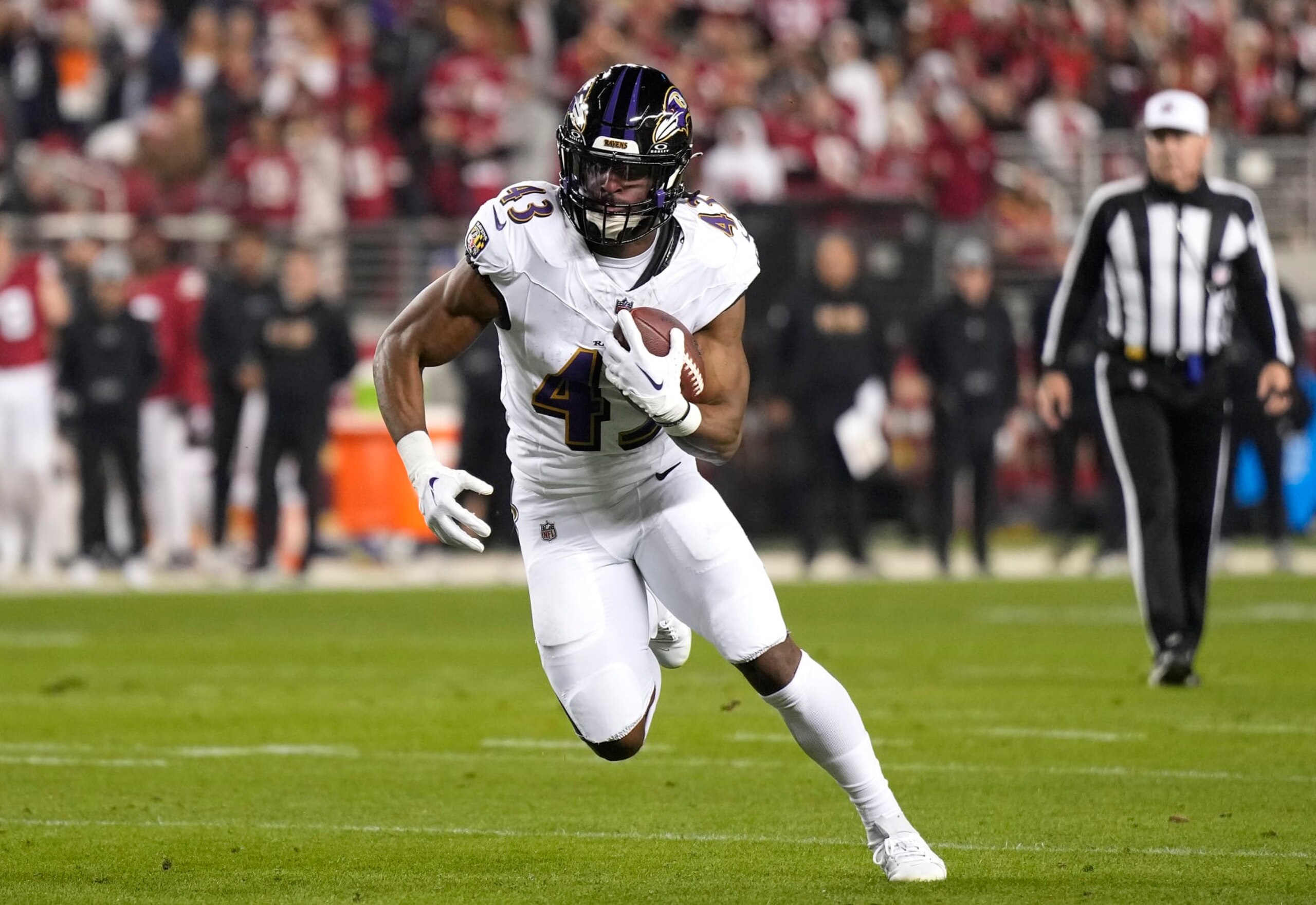 SANTA CLARA, CALIFORNIA - DECEMBER 25: Justice Hill #43 of the Baltimore Ravens carries the ball against the San Francisco 49ers during the first quarter of an NFL football game at Levi's Stadium on December 25, 2023 in Santa Clara, California. (Photo by Thearon W. Henderson/Getty Images)