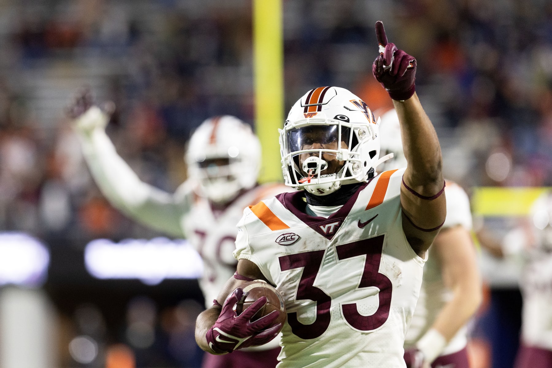 CHARLOTTESVILLE, VIRGINIA - NOVEMBER 25: Bhayshul Tuten #33 of the Virginia Tech Hokies returns a kickoff for a touchdown in the second half during a game against the Virginia Cavaliers at Scott Stadium on November 25, 2023 in Charlottesville, Virginia. (Photo by Ryan M. Kelly/Getty Images)