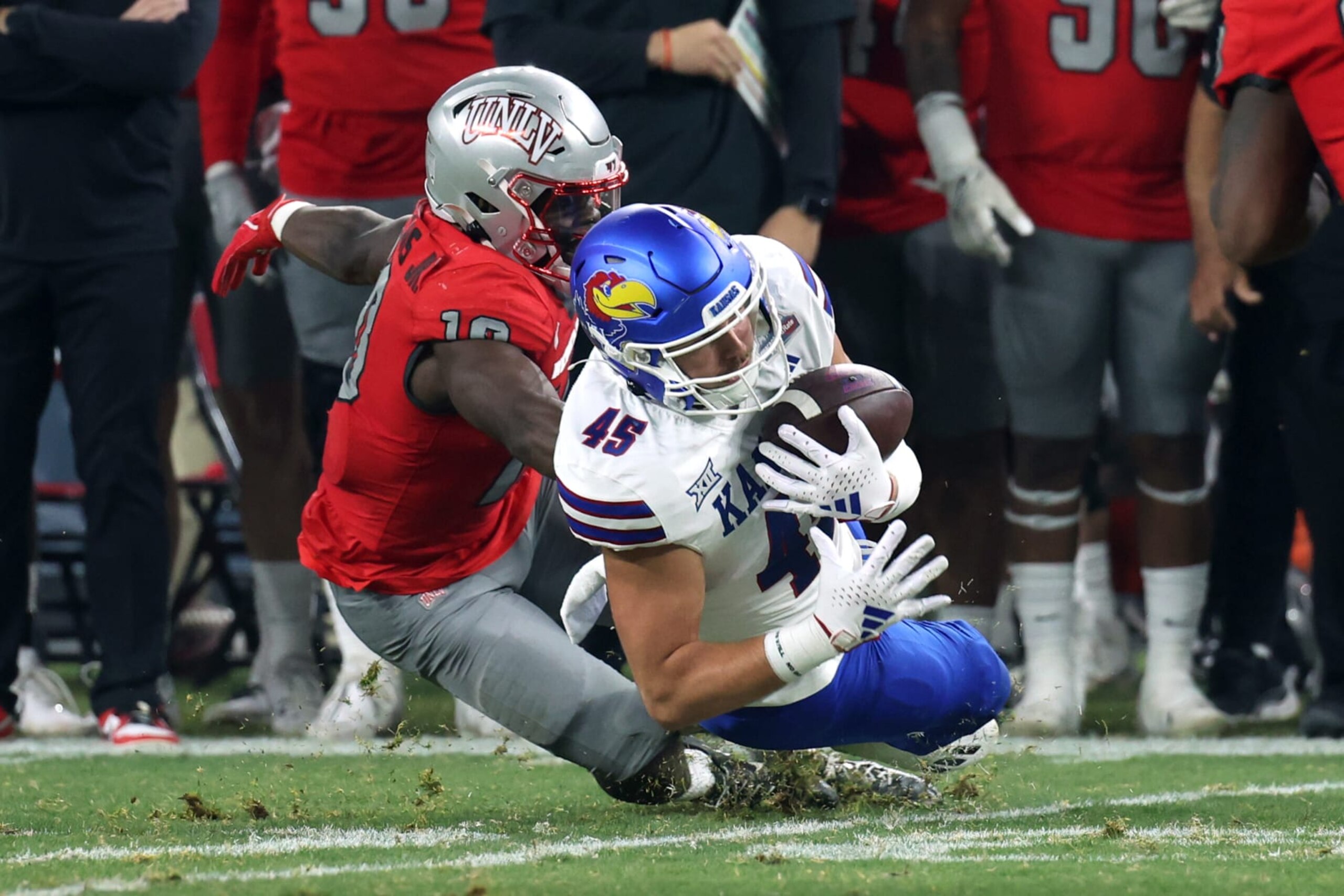 PHOENIX, AZ - DECEMBER 26: Kansas Jayhawks tight end Trevor Kardell (45) makes a catch agaisnt UNLV Rebels linebacker Fred Thompkins (10) during the second half of the Guaranteed Rate Bowl college football game between the Kansas Jayhawks and the UNLV Rebels on December 26, 2023, at Chase Field in Phoenix, AZ. (Photo by Zac BonDurant/Icon Sportswire via Getty Images)