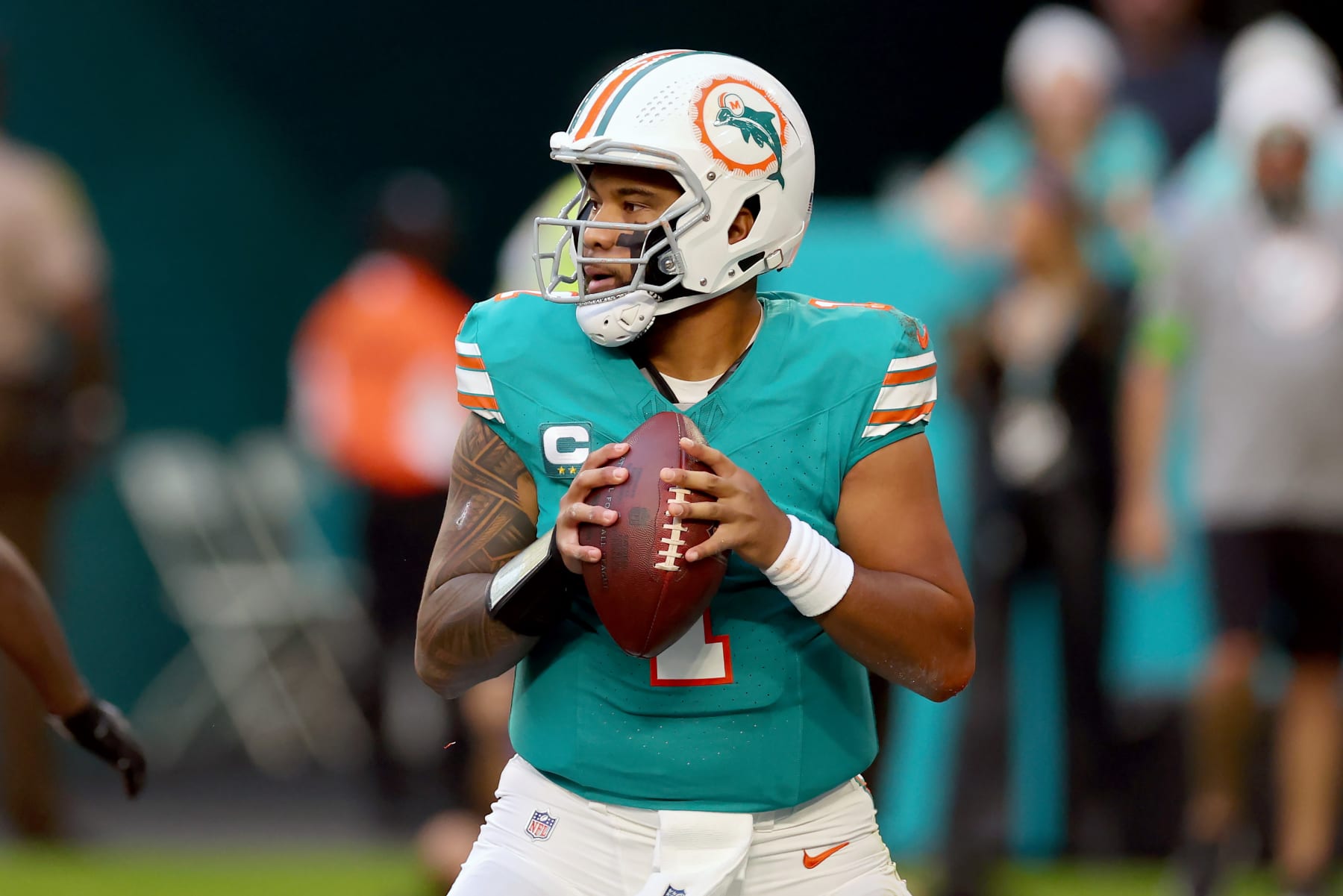 MIAMI GARDENS, FLORIDA - DECEMBER 24: Tua Tagovailoa #1 of the Miami Dolphins looks to throw a pass during the first quarter in the game against the Dallas Cowboys at Hard Rock Stadium on December 24, 2023 in Miami Gardens, Florida. (Photo by Stacy Revere/Getty Images)