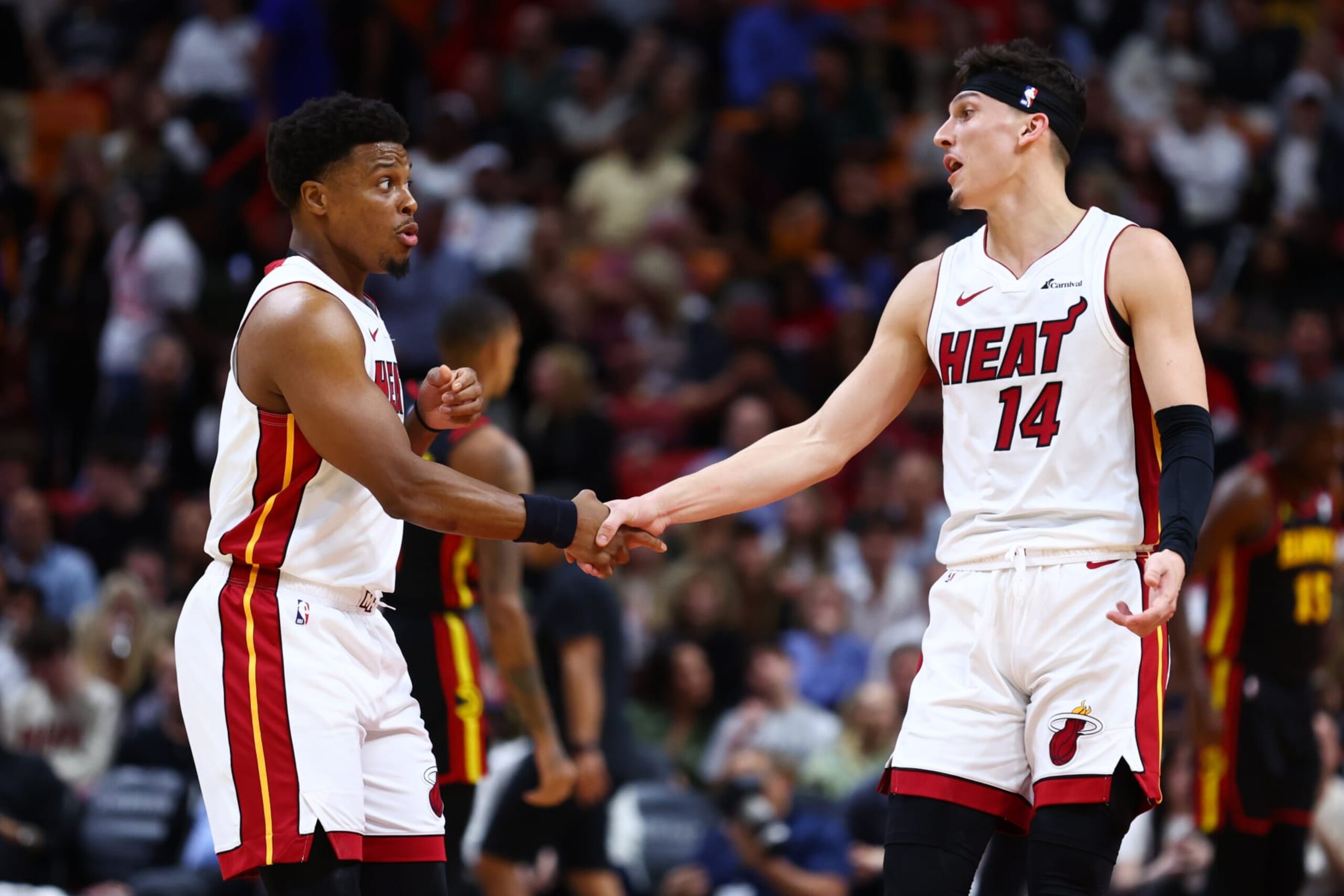 MIAMI, FLORIDA - DECEMBER 22: Kyle Lowry #7 and Tyler Herro #14 of the Miami Heat shake hands during the second quarter of the game against the Atlanta Hawks at Kaseya Center on December 22, 2023 in Miami, Florida. NOTE TO USER: User expressly acknowledges and agrees that, by downloading and or using this photograph, User is consenting to the terms and conditions of the Getty Images License Agreement. (Photo by Megan Briggs/Getty Images)