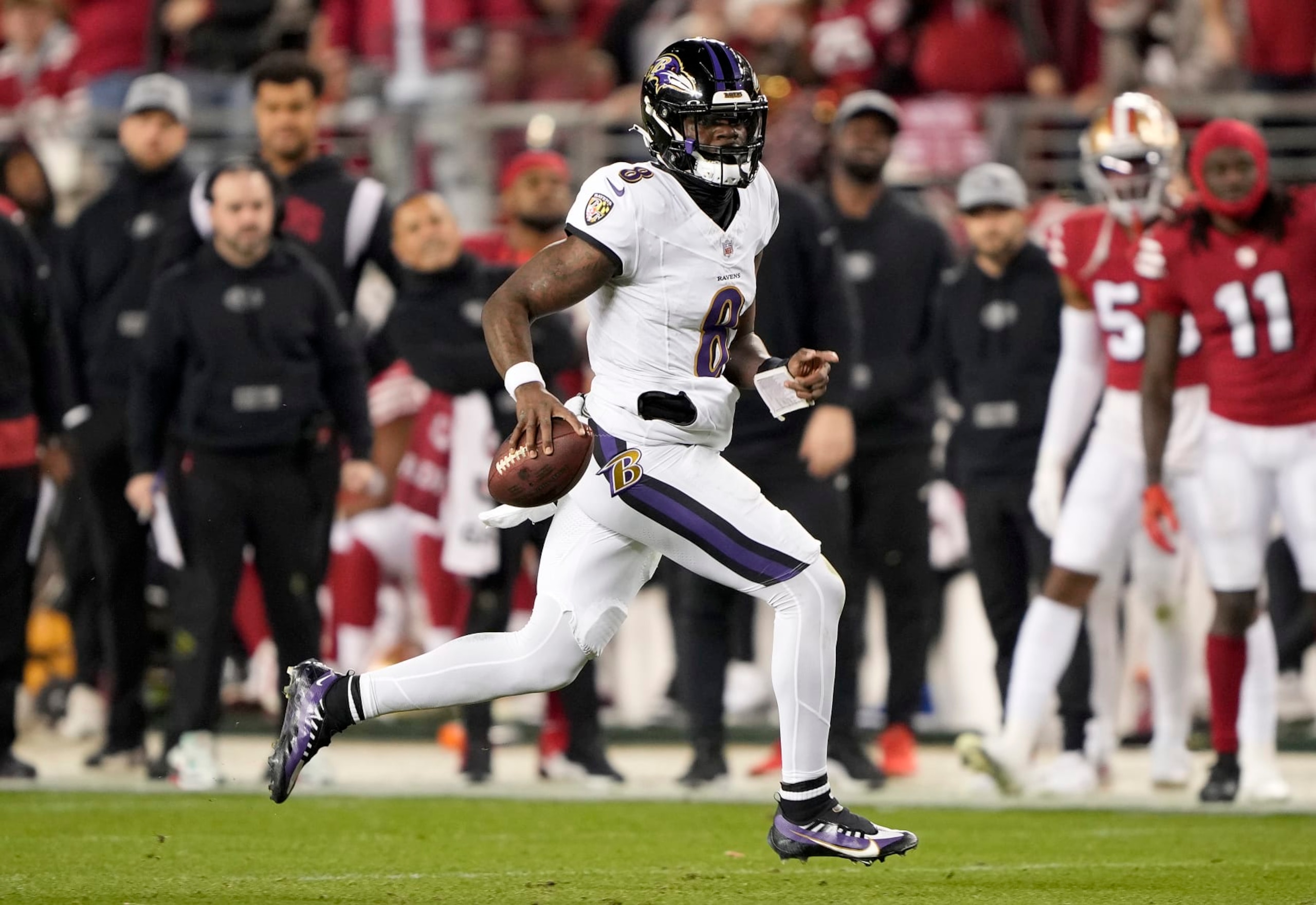 SANTA CLARA, CALIFORNIA - DECEMBER 25: Lamar Jackson #8 of the Baltimore Ravens scrambles with the ball against the San Francisco 49ers during the second quarter of an NFL football game at Levi's Stadium on December 25, 2023 in Santa Clara, California. (Photo by Thearon W. Henderson/Getty Images)