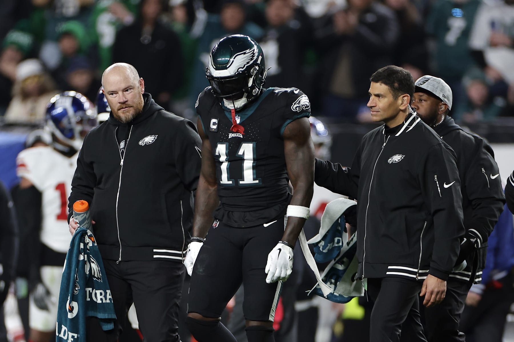 PHILADELPHIA, PENNSYLVANIA - DECEMBER 25: A.J. Brown #11 of the Philadelphia Eagles walks off the field with medical personnel during the third quarter against the New York Giants at Lincoln Financial Field on December 25, 2023 in Philadelphia, Pennsylvania. (Photo by Adam Hunger/Getty Images)
