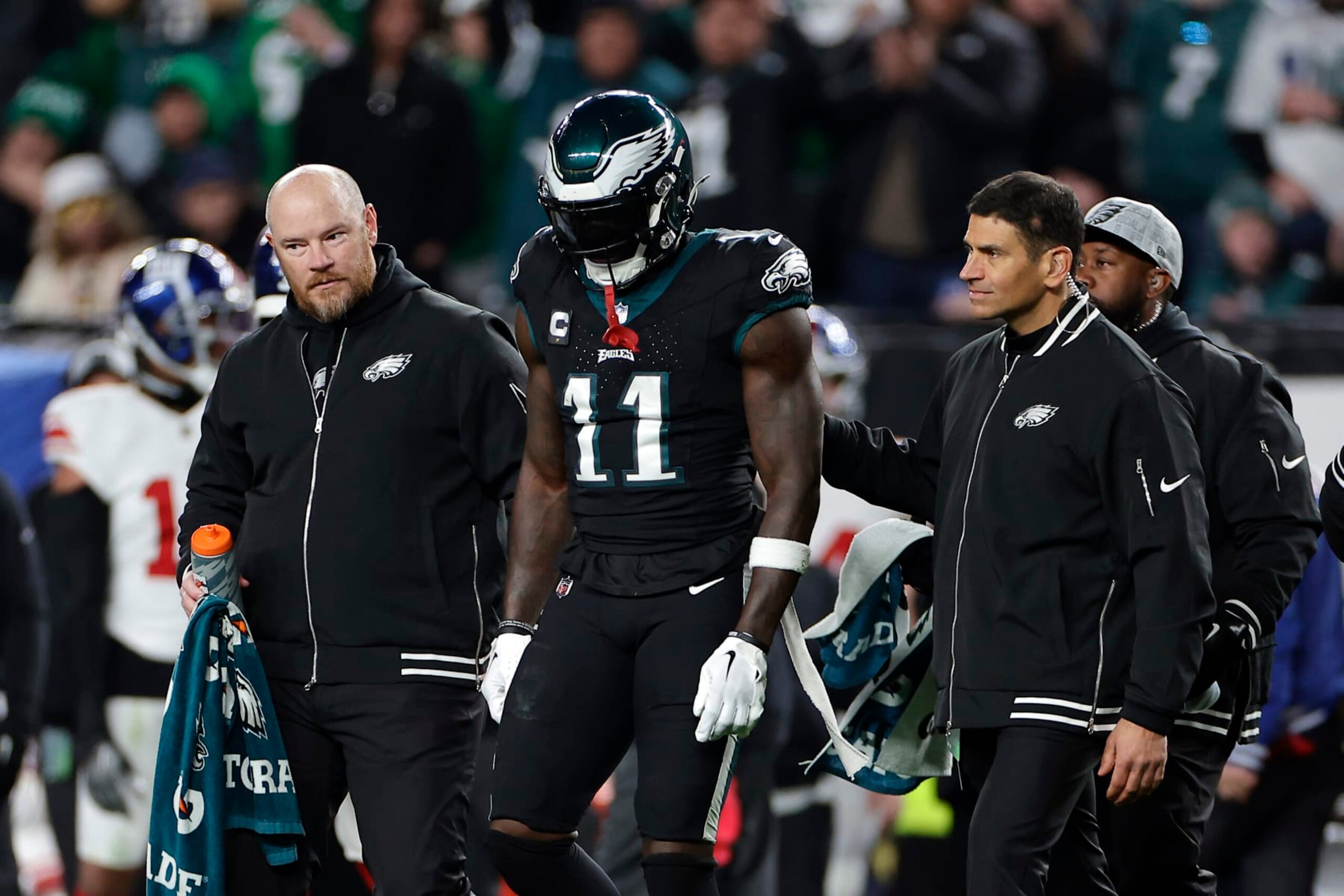 PHILADELPHIA, PENNSYLVANIA - DECEMBER 25: A.J. Brown #11 of the Philadelphia Eagles walks off the field with medical personnel during the third quarter against the New York Giants at Lincoln Financial Field on December 25, 2023 in Philadelphia, Pennsylvania. (Photo by Adam Hunger/Getty Images)