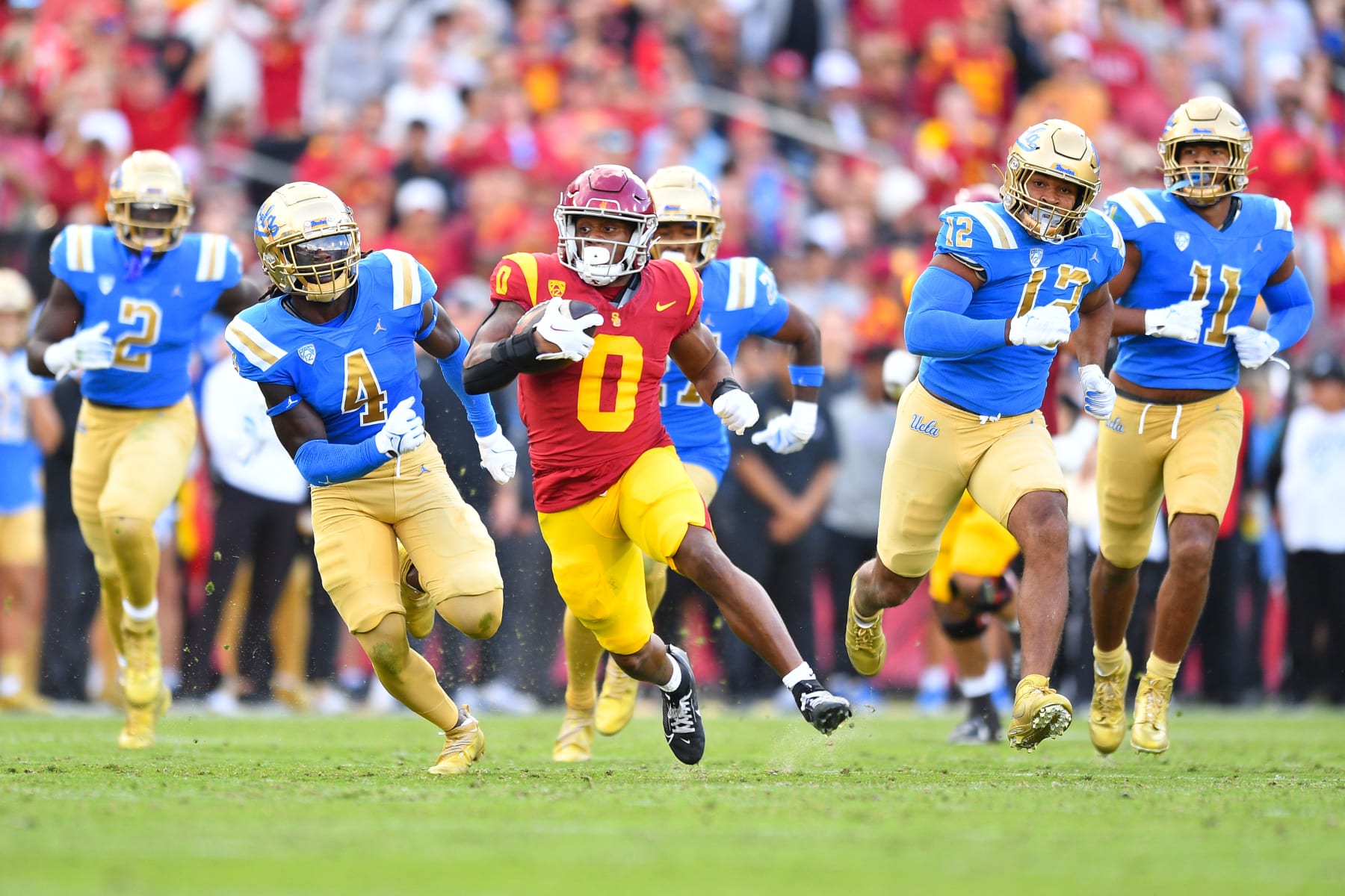 LOS ANGELES, CA - NOVEMBER 18: UCLA Bruins linebacker Carl Jones Jr. (4) and linebacker Grayson Murphy (12) try to chase down USC Trojans running back MarShawn Lloyd (0) during a college football game between the UCLA Bruins and the USC Trojans on November 18, 2023, at Los Angeles Memorial Coliseum in Los Angeles, CA. (Photo by Brian Rothmuller/Icon Sportswire via Getty Images)