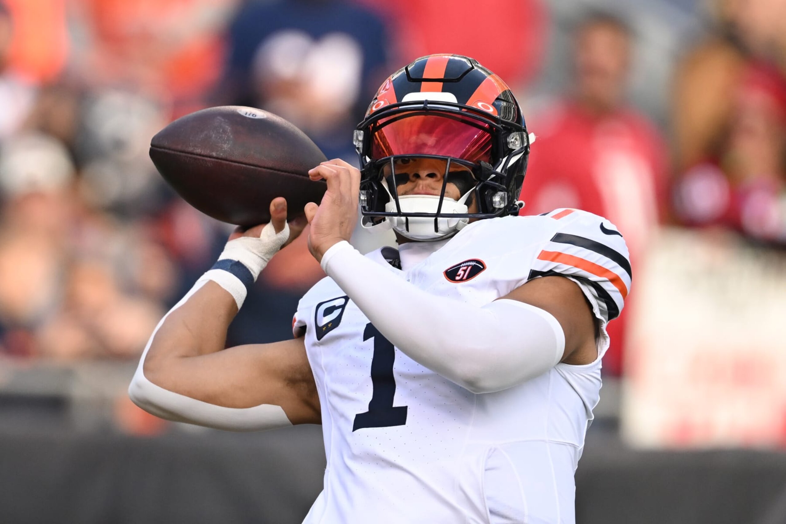 CHICAGO, ILLINOIS - DECEMBER 24: Justin Fields #1 of the Chicago Bears warms up before the game against the Arizona Cardinals at Soldier Field on December 24, 2023 in Chicago, Illinois. (Photo by Quinn Harris/Getty Images)