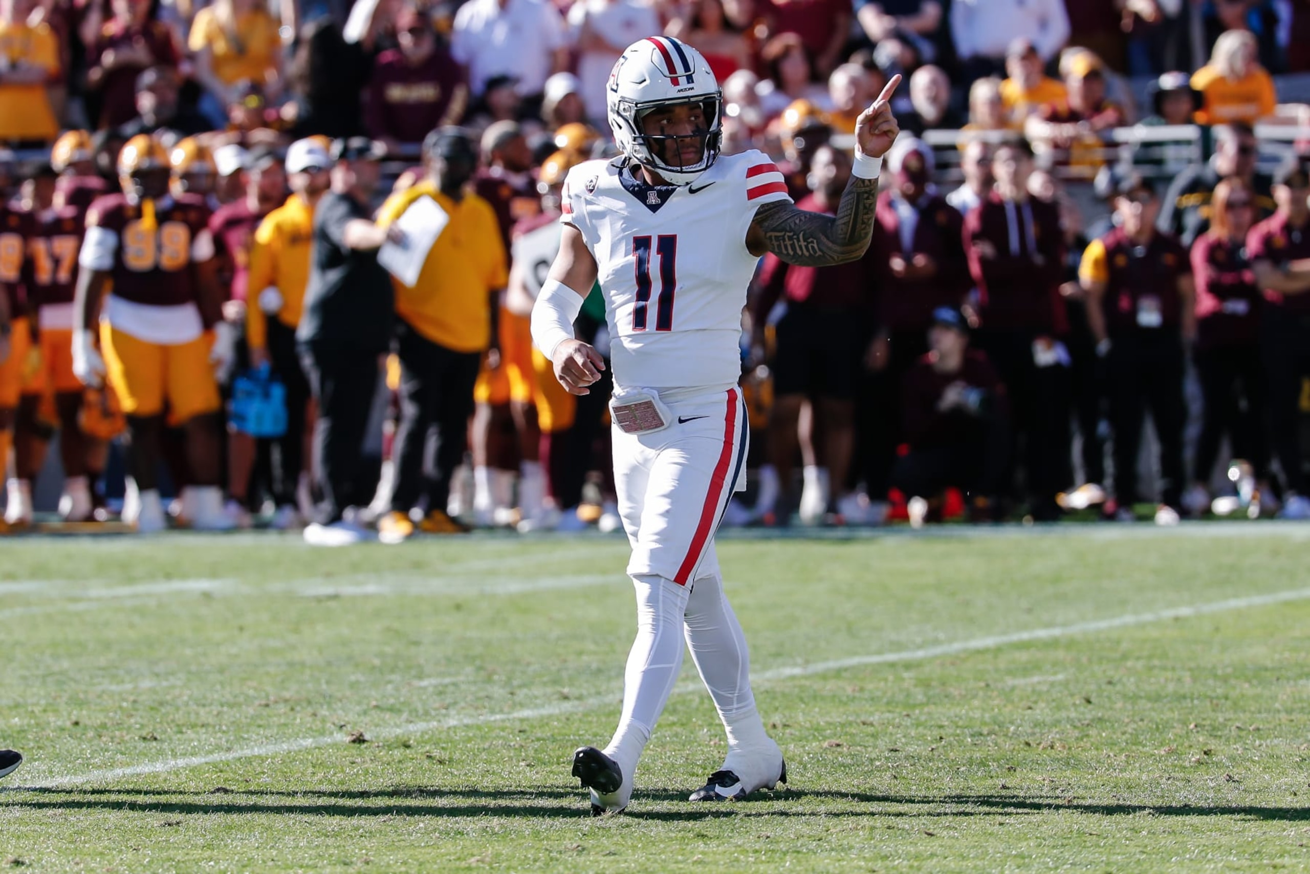 TEMPE, AZ - NOVEMBER 25: Arizona Wildcats quarterback Noah Fifita (11) points during the college football game between the Arizona Wildcats and the Arizona State Sun Devils on November 25, 2023 at Mountain America Stadium in Tempe, Arizona. (Photo by Kevin Abele/Icon Sportswire via Getty Images) TEMPE, AZ - NOVEMBER 25: Arizona Wildcats quarterback Noah Fifita (11) points during the college football game between the Arizona Wildcats and the Arizona State Sun Devils on November 25, 2023 at Mountain America Stadium in Tempe, Arizona. (Photo by Kevin Abele/Icon Sportswire via Getty Images)