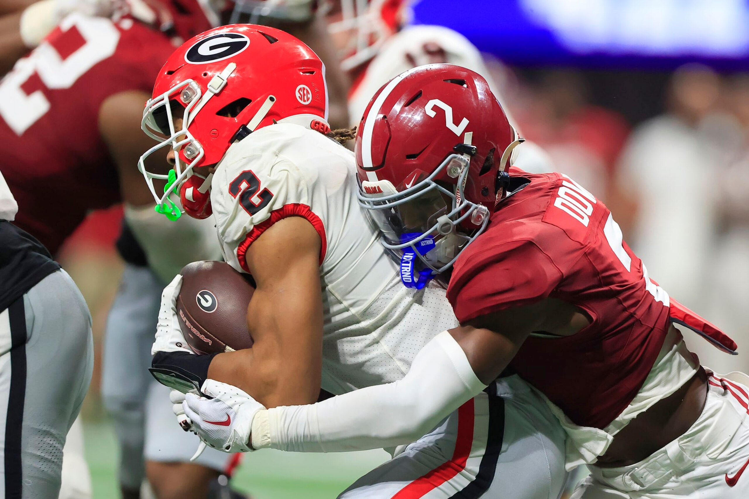 ATLANTA, GA - DECEMBER 02:  Alabama Crimson Tide defensive back Caleb Downs (2) tackles  Georgia Bulldogs running back Kendall Milton (2) during the college football SEC Championship game between the Alabama Crimson Tide and the Georgia Bulldogs on December 2, 2023 at the Mercedes-Benz Stadium in Atlanta, GA.  (Photo by David J. Griffin/Icon Sportswire via Getty Images)