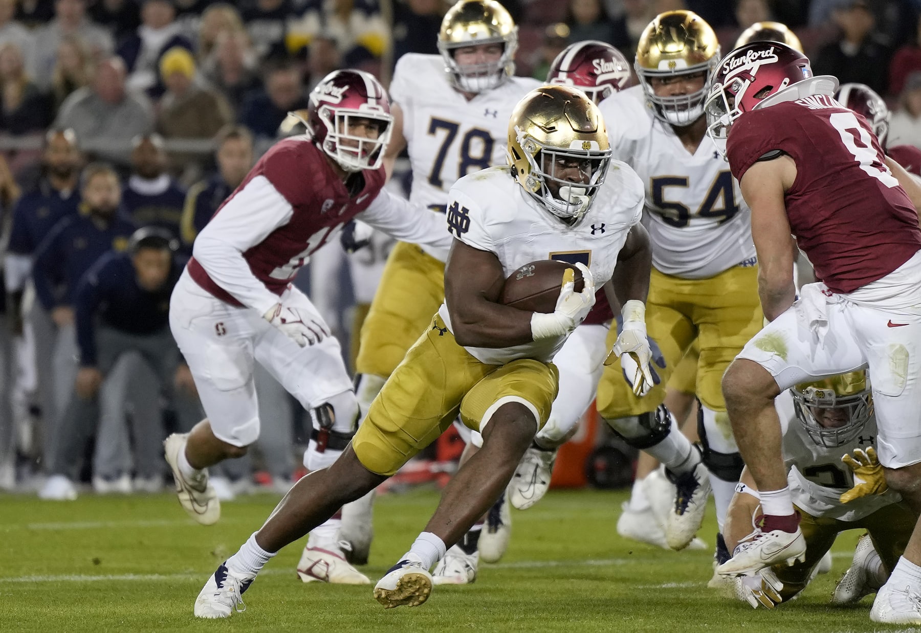 STANFORD, CALIFORNIA - NOVEMBER 25: Audric Estime #7 of the Notre Dame Fighting rushes for a six yard touchdown against the Stanford Cardinal during the second quarter at Stanford Stadium on November 25, 2023 in Stanford, California. (Photo by Thearon W. Henderson/Getty Images)