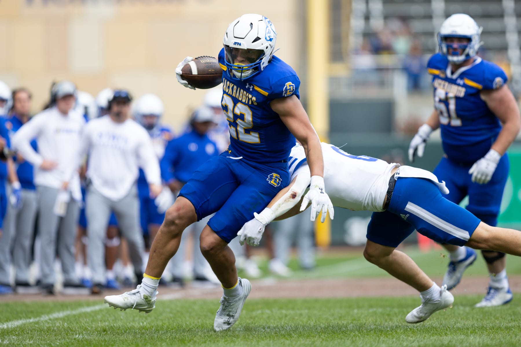 MINNEAPOLIS, MN - SEPTEMBER 16: South Dakota State Jackrabbits running back Isaiah Davis (22) runs with the ball after breaking a tackle attempt from Drake Bulldogs defensive back Tyler Radocha (6) during the college football game between the South Dakota State Jackrabbits and the Drake Bulldogs on September 16th, 2023, at Target Field in Minneapolis, MN. (Photo by Bailey Hillesheim/Icon Sportswire via Getty Images)
