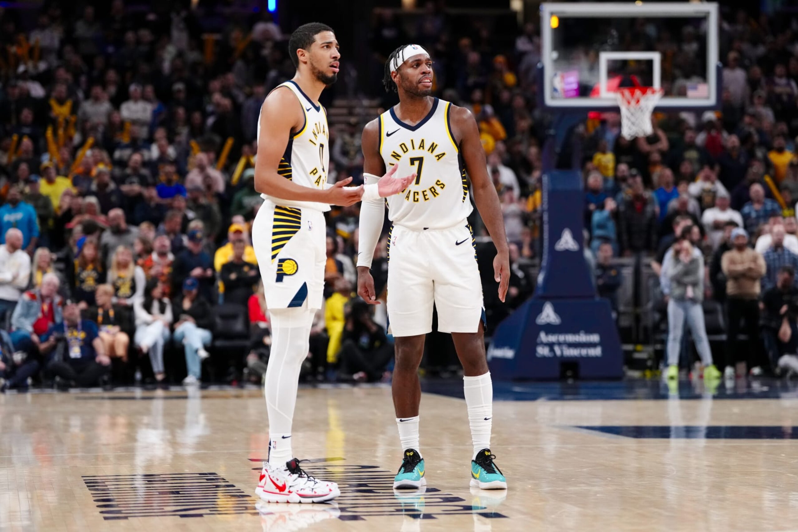 INDIANAPOLIS, INDIANA - NOVEMBER 22: Tyrese Haliburton #0 and Buddy Hield #7 of the Indiana Pacers meet in the fourth quarter against the Toronto Raptors at Gainbridge Fieldhouse on November 22, 2023 in Indianapolis, Indiana. NOTE TO USER: User expressly acknowledges and agrees that, by downloading and or using this photograph, User is consenting to the terms and conditions of the Getty Images License Agreement. (Photo by Dylan Buell/Getty Images)