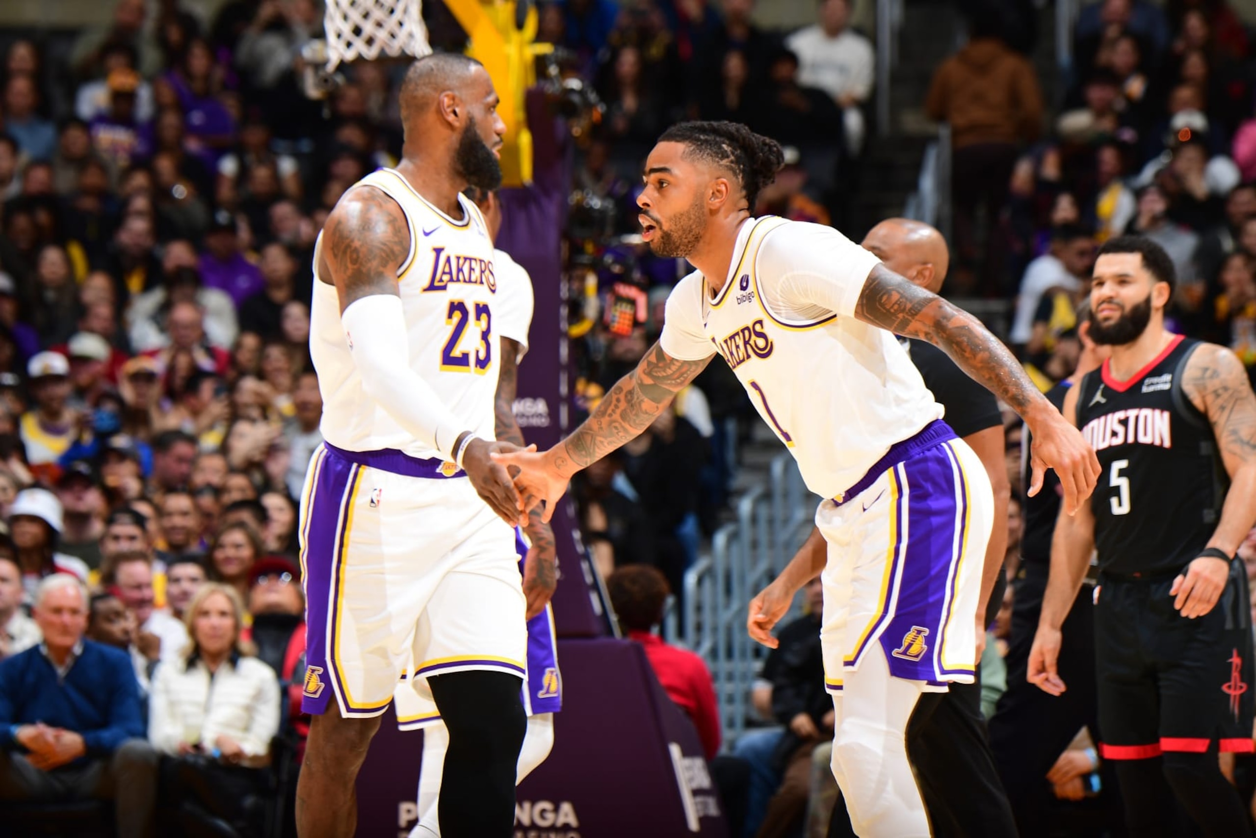 LOS ANGELES, CA - DECEMBER 2: D'Angelo Russell #1 and LeBron James #23  of the Los Angeles Lakers high five during the game against the Houston Rockets on December 2, 2023 at Crypto.Com Arena in Los Angeles, California. NOTE TO USER: User expressly acknowledges and agrees that, by downloading and/or using this Photograph, user is consenting to the terms and conditions of the Getty Images License Agreement. Mandatory Copyright Notice: Copyright 2023 NBAE (Photo by Adam Pantozzi/NBAE via Getty Images)