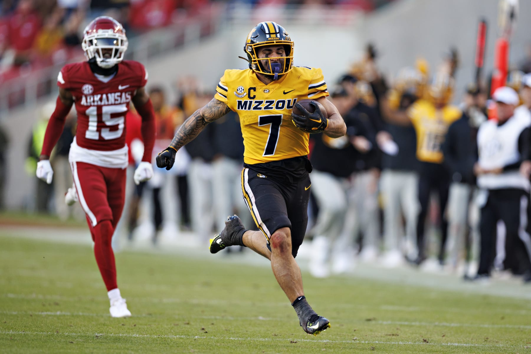 FAYETTEVILLE, ARKANSAS - NOVEMBER 24: Cody Schrader #7 of the Missouri Tigers runs the ball in the first half of the game against the Arkansas Razorbacks at Donald W. Reynolds Razorback Stadium on November 24, 2023 in Fayetteville, Arkansas. (Photo by Wesley Hitt/Getty Images)