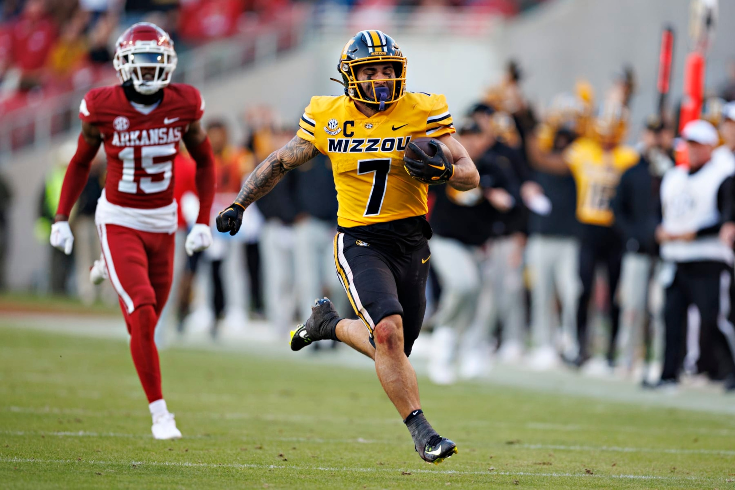 FAYETTEVILLE, ARKANSAS - NOVEMBER 24: Cody Schrader #7 of the Missouri Tigers runs the ball in the first half of the game against the Arkansas Razorbacks at Donald W. Reynolds Razorback Stadium on November 24, 2023 in Fayetteville, Arkansas. (Photo by Wesley Hitt/Getty Images)