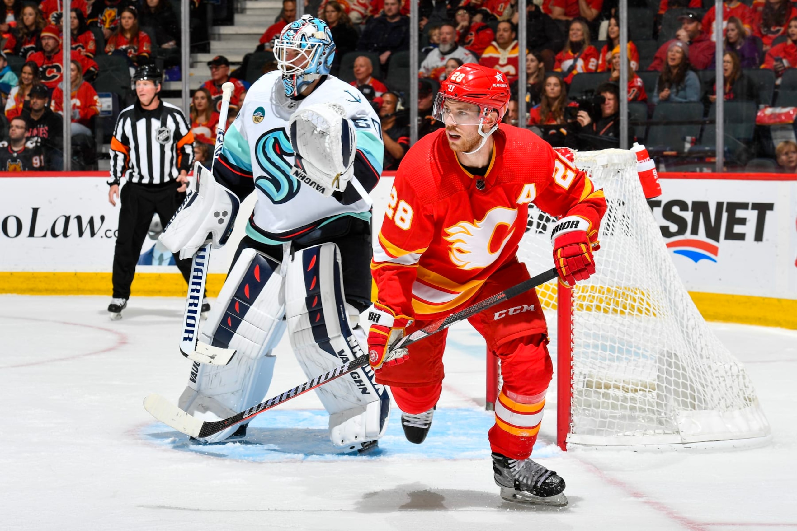 CALGARY, ALBERTA - DECEMBER 27: Elias Lindholm #28 of the Calgary Flames skates against Chris Driedger #60 of the Seattle Kraken at the Scotiabank Saddledome on December 27, 2023 in Calgary, Alberta. (Photo by Terence Leung/NHLI via Getty Images)
