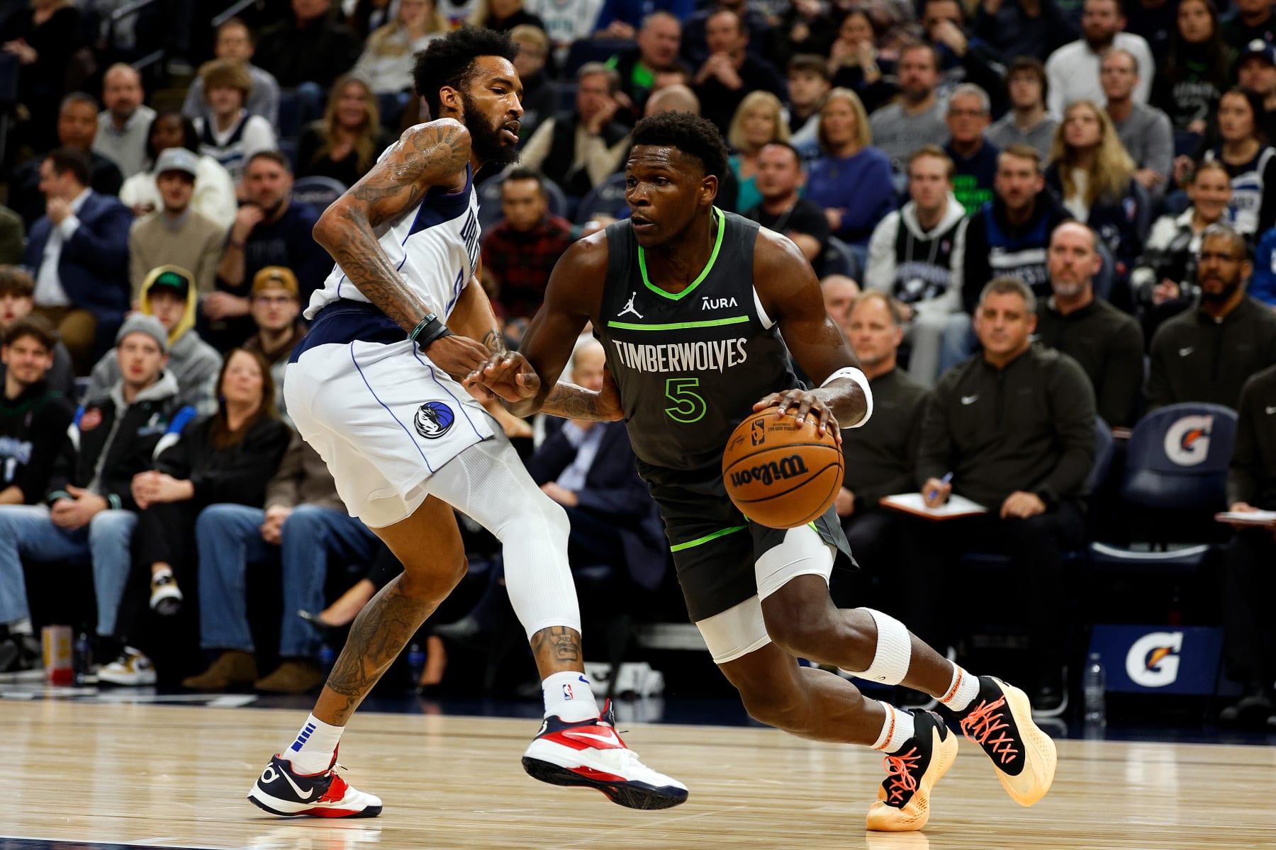 MINNEAPOLIS, MINNESOTA - DECEMBER 28: Anthony Edwards #5 of the Minnesota Timberwolves drives to the basket while Derrick Jones Jr. #55 of the Dallas Mavericks defends in the first quarter at Target Center on December 28, 2023 in Minneapolis, Minnesota. NOTE TO USER: User expressly acknowledges and agrees that, by downloading and or using this photograph, User is consenting to the terms and conditions of the Getty Images License Agreement. (Photo by David Berding/Getty Images)