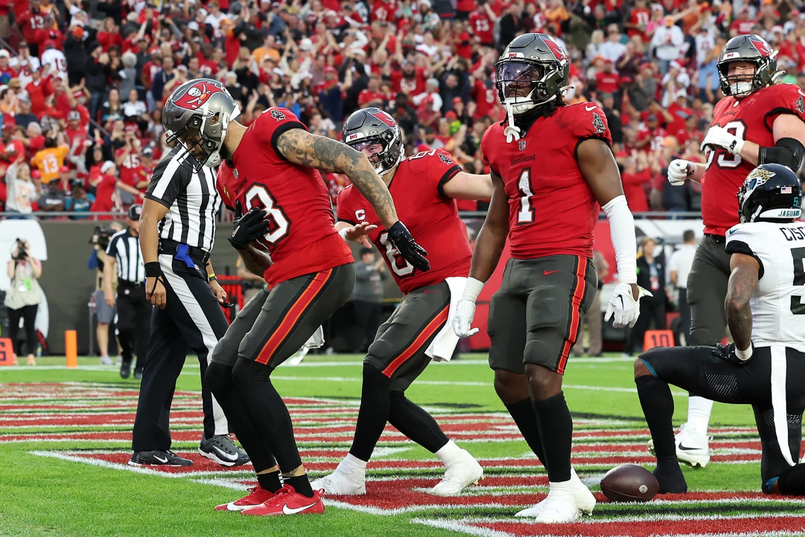 TAMPA, FLORIDA - DECEMBER 24:  Mike Evans #13 of the Tampa Bay Buccaneers celebrates with his teammates after scoring his second touchdown reception of the second quarter against the Jacksonville Jaguars at Raymond James Stadium on December 24, 2023 in Tampa, Florida. (Photo by Mike Carlson/Getty Images)