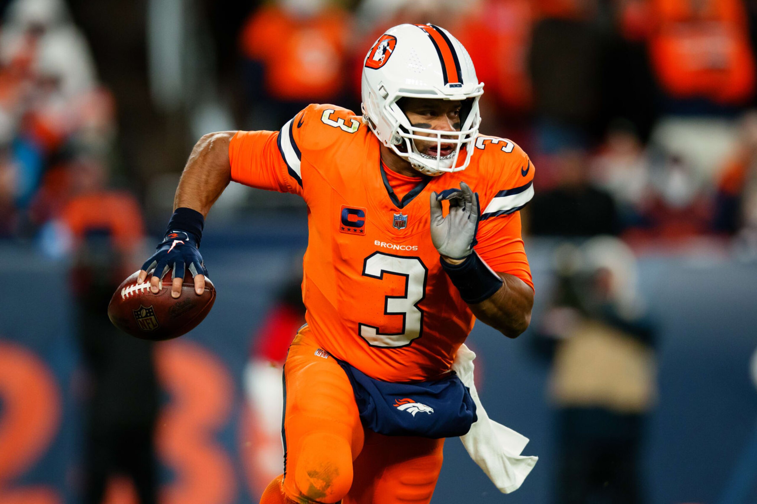 DENVER, CO - JANUARY 24:  Quarterback Russell Wilson #3 of the Denver Broncos scrambles out of the pocket during the third quarter against the New England Patriots at Empower Field at Mile High on December 24, 2023 in Denver, Colorado. (Photo by Justin Edmonds/Getty Images)