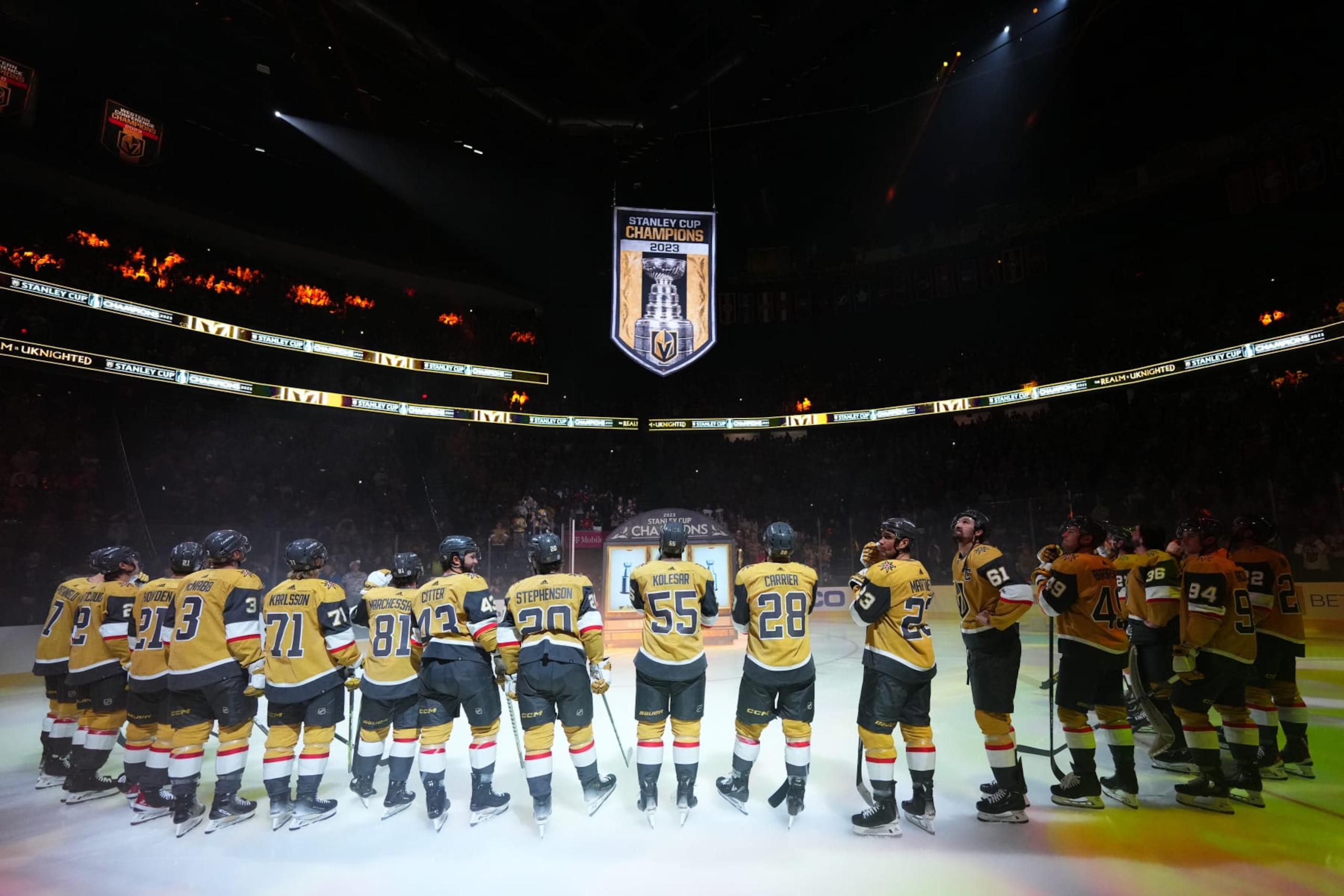 LAS VEGAS, NEVADA - OCTOBER 10: The Vegas Golden Knights look on as the Stanley Cup Championship banner is raised prior to a game against the Seattle Kraken at T-Mobile Arena on October 10, 2023 in Las Vegas, Nevada. (Photo by Jeff Bottari/NHLI via Getty Images)
