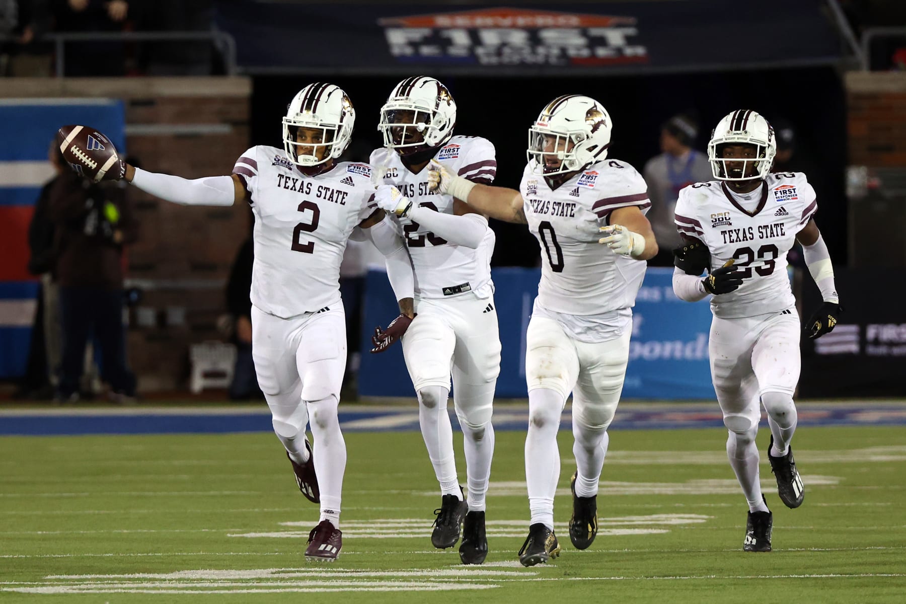 DALLAS, TEXAS - DECEMBER 26: Kaleb Ford-Dement #2, Dontavius Burrows #29, Brian Holloway #0, Shawn Holton #23 of the Texas State Bobcats celebrate an interception by Ford-Dement in the fourth quarter against the Rice Owls during the SERVPRO First Responder Bowl at Gerald J. Ford Stadium on December 26, 2023 in Dallas, Texas. (Photo by Richard Rodriguez/Getty Images)