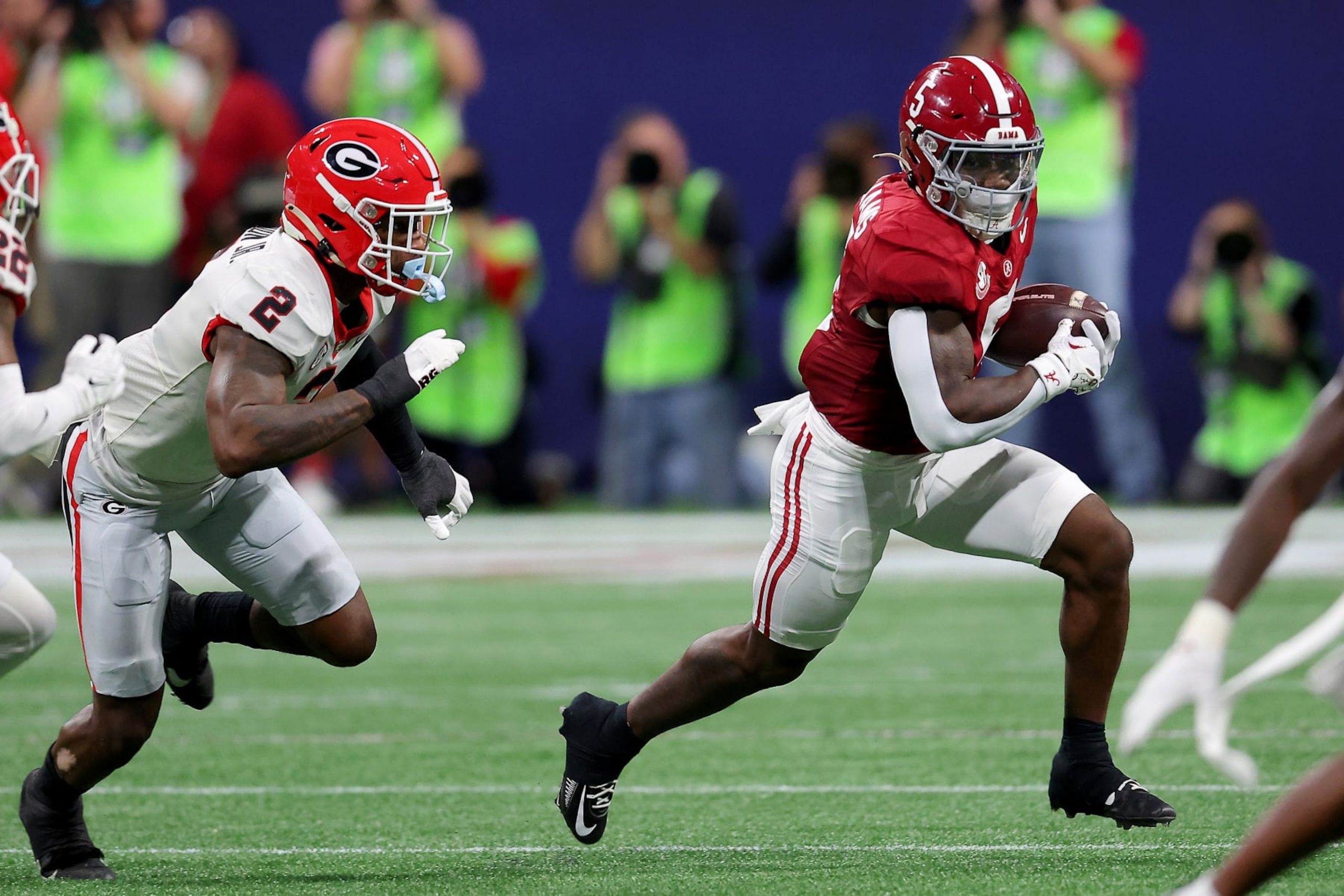 ATLANTA, GEORGIA - DECEMBER 02: Roydell Williams #5 of the Alabama Crimson Tide rushes the ball against Smael Mondon Jr. #2 of the Georgia Bulldogs during the first quarter in the SEC Championship at Mercedes-Benz Stadium on December 02, 2023 in Atlanta, Georgia. (Photo by Kevin C. Cox/Getty Images)