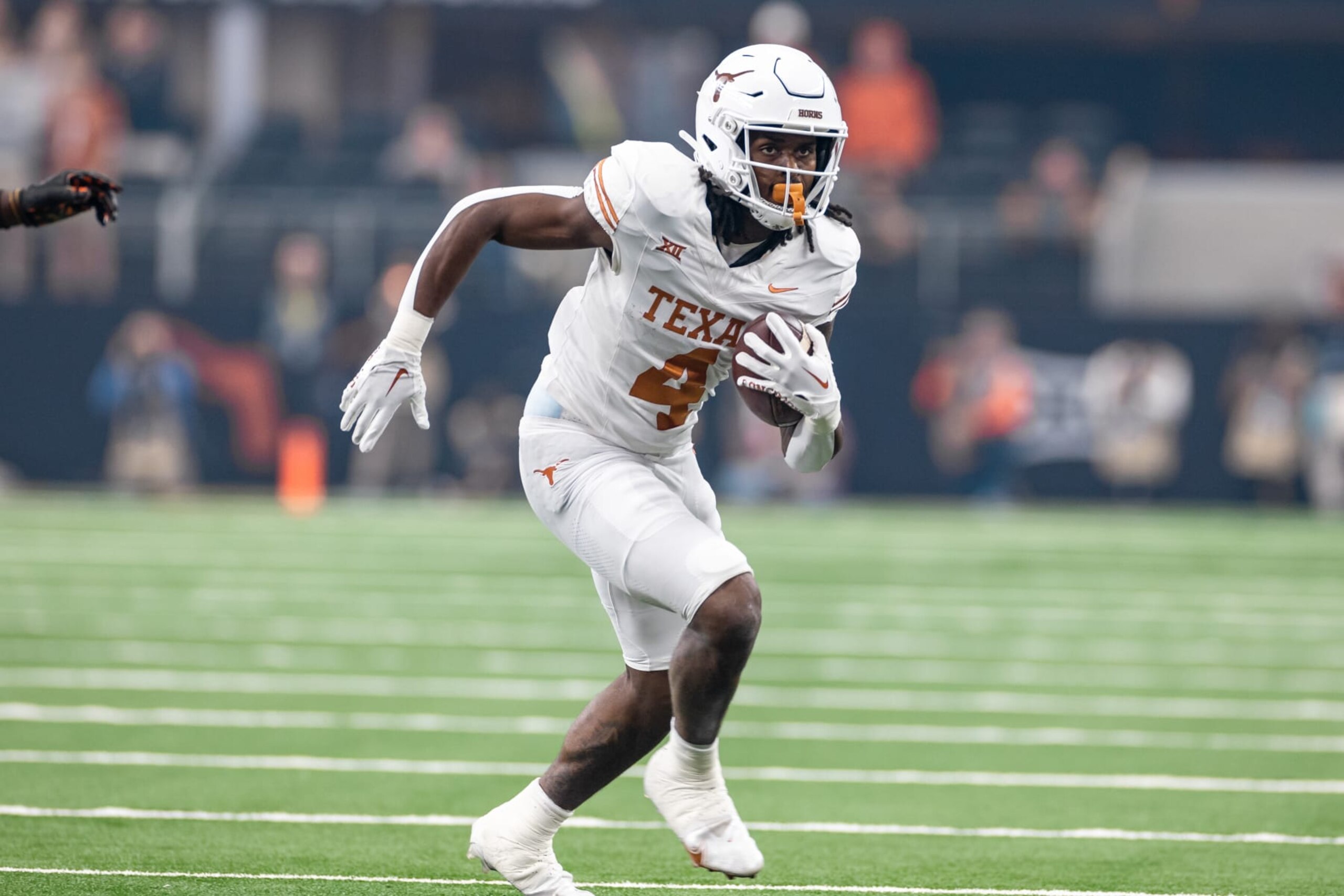 ARLINGTON, TX - DECEMBER 02: Texas Longhorns running back CJ Baxter (#4) runs up field during the Big 12 Championship football game between the Texas Longhorns and Oklahoma State Cowboys on December 02, 2023 at AT&T Studium in Arlington, Texas. (Photo by Matthew Visinsky/Icon Sportswire via Getty Images)