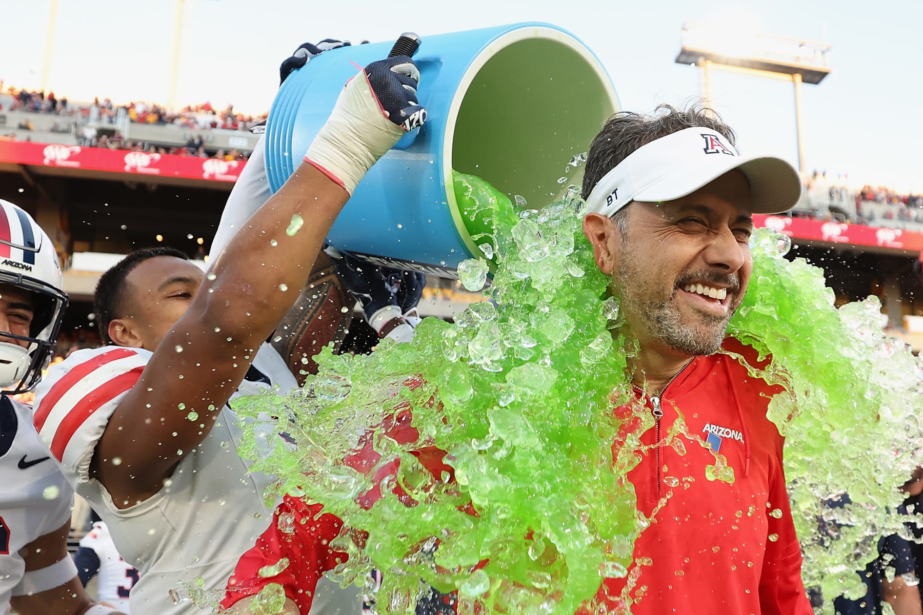 TEMPE, ARIZONA - NOVEMBER 25: Head coach Jedd Fisch of the Arizona Wildcats is dunked with powerade from Jacob Manu #5 during the final moments of the NCAAF game against the Arizona State Sun Devils at Mountain America Stadium on November 25, 2023 in Tempe, Arizona. The Wildcats defeated the Sun Devils 59-23. (Photo by Christian Petersen/Getty Images)