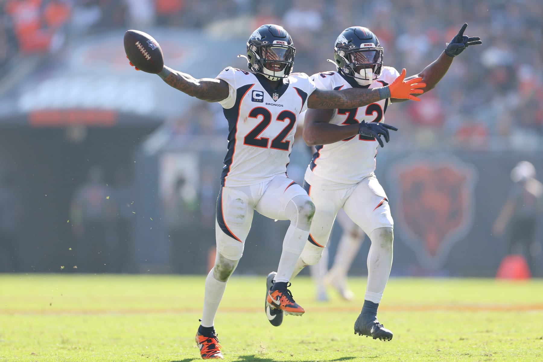 CHICAGO, ILLINOIS - OCTOBER 01: Kareem Jackson #22 of the Denver Broncos celebrates with Delarrin Turner-Yell #32 after intercepting a pass from Justin Fields #1 of the Chicago Bears during the fourth quarter at Soldier Field on October 01, 2023 in Chicago, Illinois. (Photo by Michael Reaves/Getty Images)