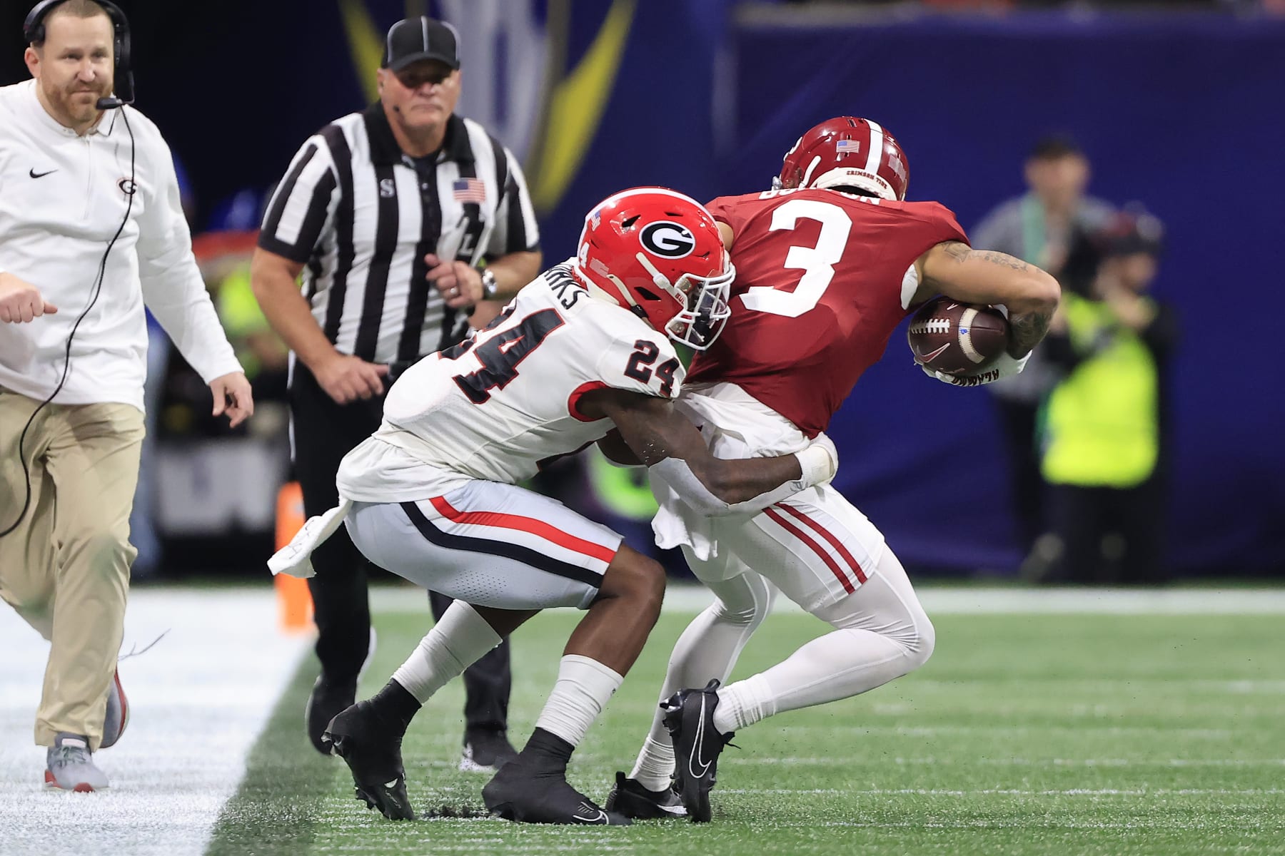 ATLANTA, GA - DECEMBER 02:  Georgia Bulldogs defensive back Malaki Starks (24) tackles Alabama Crimson Tide wide receiver Jermaine Burton (3) during the college football SEC Championship game between the Alabama Crimson Tide and the Georgia Bulldogs on December 2, 2023 at the Mercedes-Benz Stadium in Atlanta, GA.  (Photo by David J. Griffin/Icon Sportswire via Getty Images)