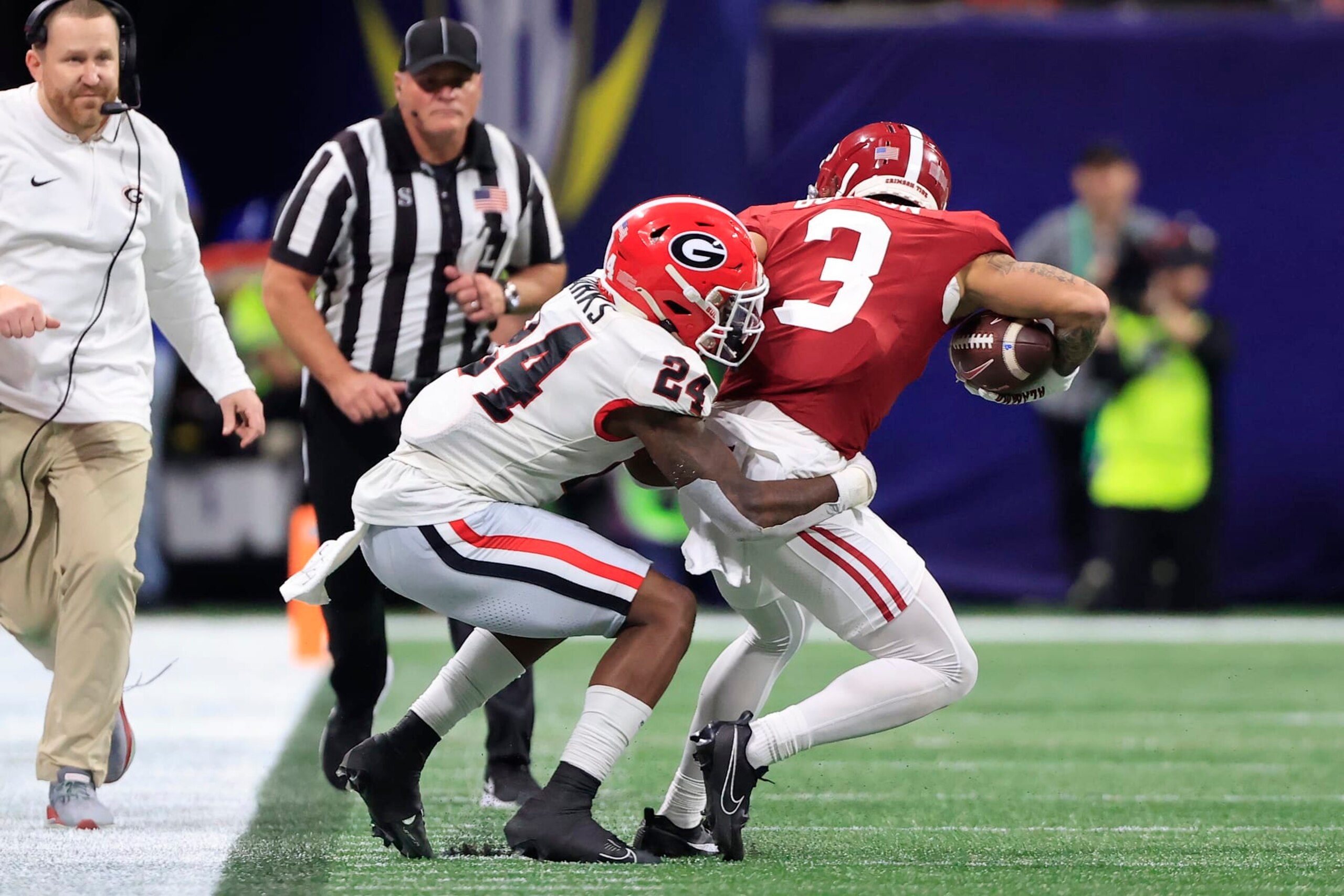 ATLANTA, GA - DECEMBER 02:  Georgia Bulldogs defensive back Malaki Starks (24) tackles Alabama Crimson Tide wide receiver Jermaine Burton (3) during the college football SEC Championship game between the Alabama Crimson Tide and the Georgia Bulldogs on December 2, 2023 at the Mercedes-Benz Stadium in Atlanta, GA.  (Photo by David J. Griffin/Icon Sportswire via Getty Images)