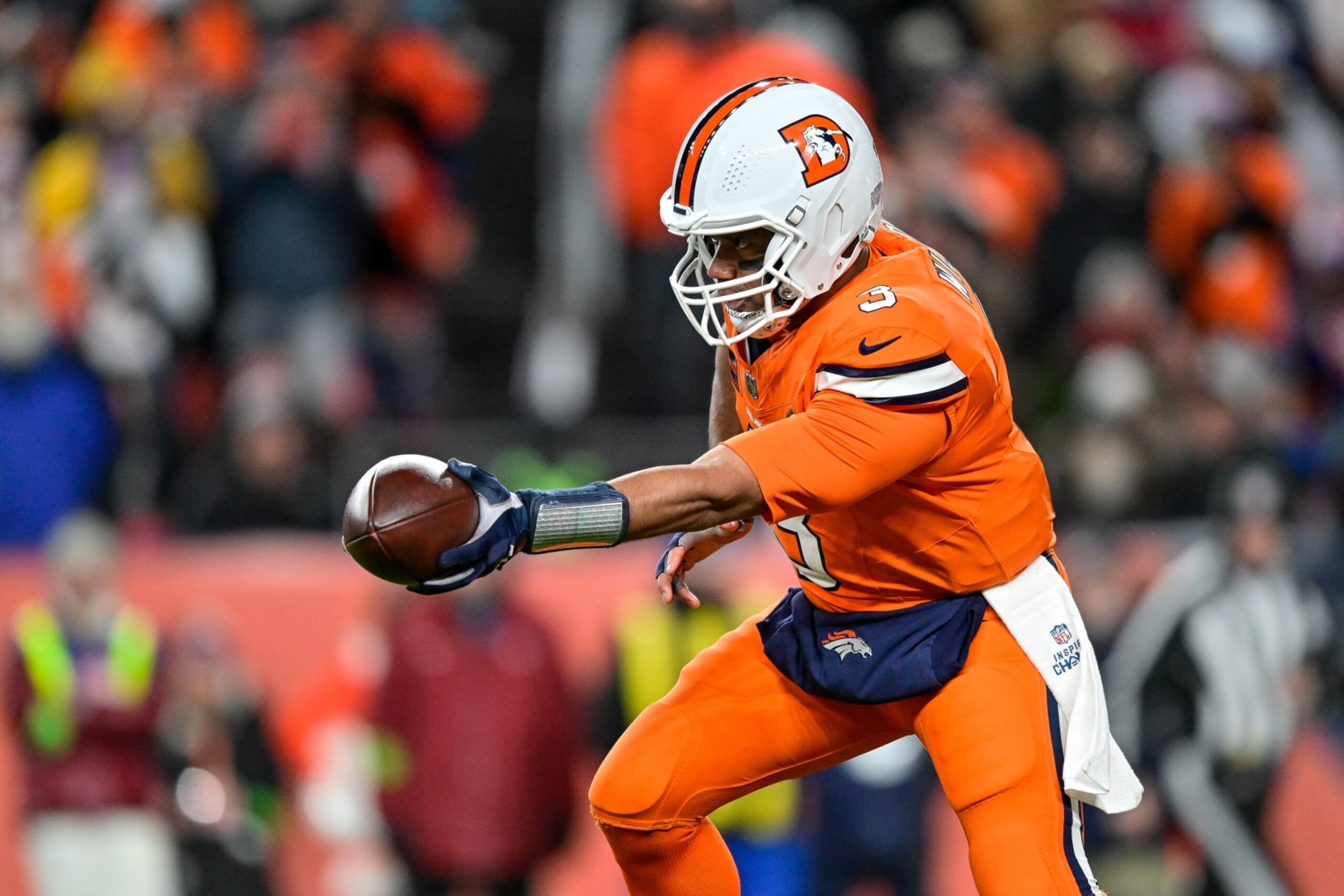 DENVER, COLORADO - DECEMBER 24:  Russell Wilson #3 of the Denver Broncos sets to hand off against the New England Patriots in the first quarter at Empower Field at Mile High on December 24, 2023 in Denver, Colorado. (Photo by Dustin Bradford/Getty Images)