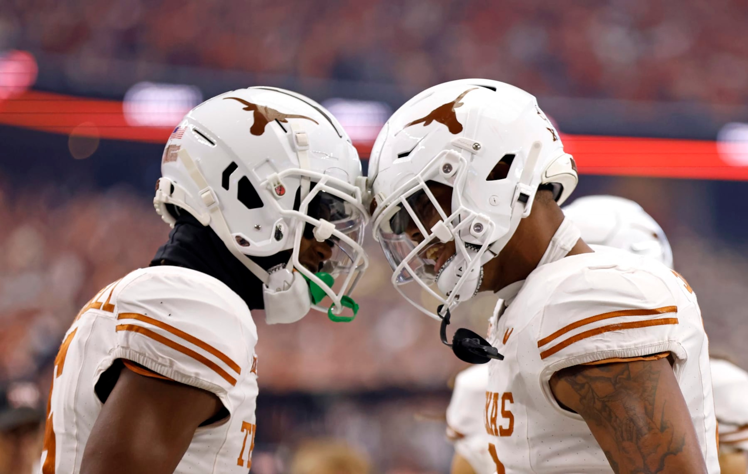 ARLINGTON, TX - DECEMBER 2: Wide receiver Adonai Mitchell #5 and tight end Ja'Tavion Sanders #0 of the Texas Longhorns celebrate a touchdown against the Oklahoma State Cowboys in the first half of the Big 12  Championship at AT&T Stadium on December 2, 2023 in Arlington, Texas.  (Photo by Ron Jenkins/Getty Images)