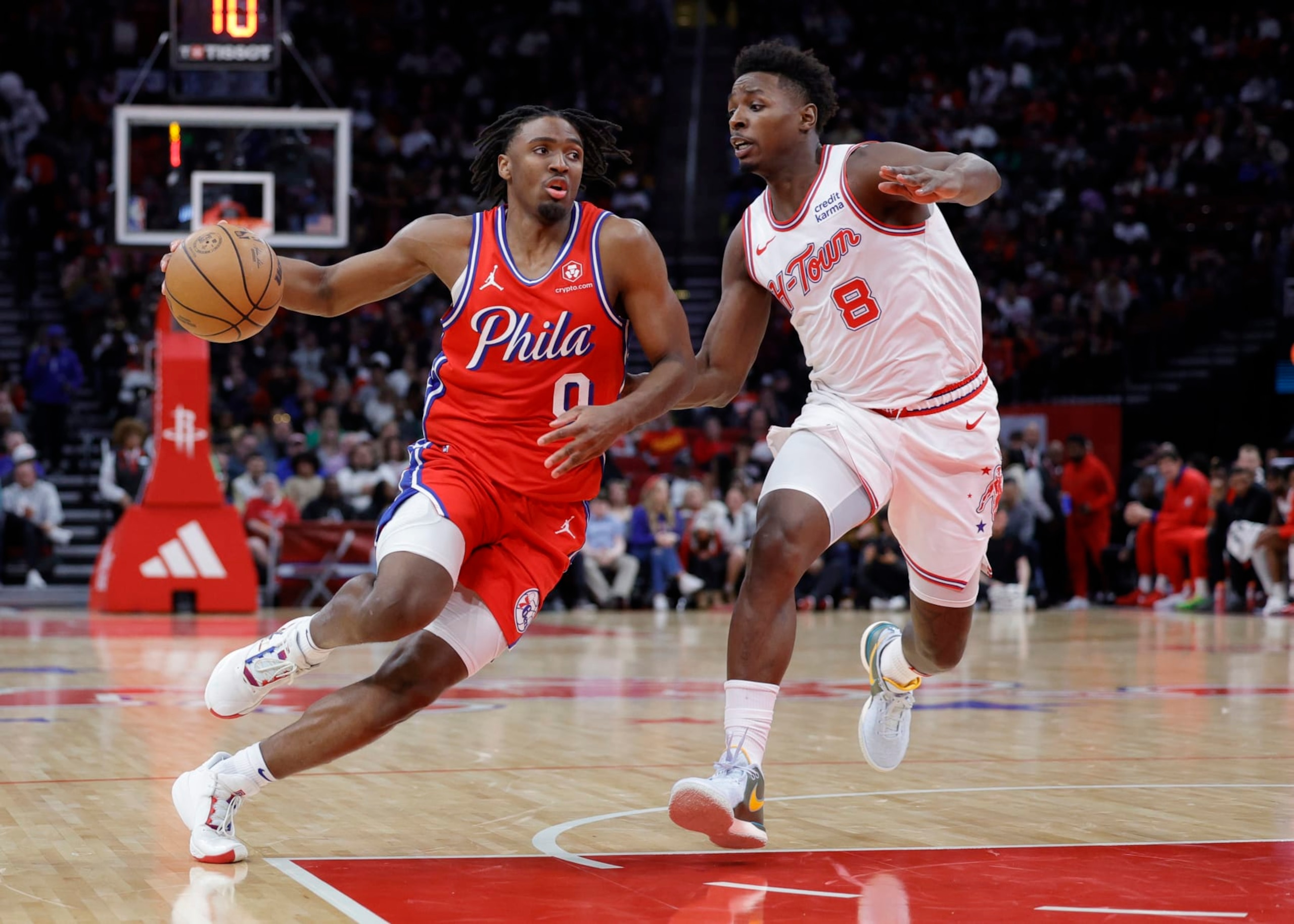 HOUSTON, TEXAS - DECEMBER 29: Tyrese Maxey #0 of the Philadelphia 76ers controls the ball around Jae'Sean Tate #8 of the Houston Rockets during the first half at Toyota Center on December 29, 2023 in Houston, Texas. NOTE TO USER: User expressly acknowledges and agrees that, by downloading and or using this photograph, User is consenting to the terms and conditions of the Getty Images License Agreement.  (Photo by Carmen Mandato/Getty Images)